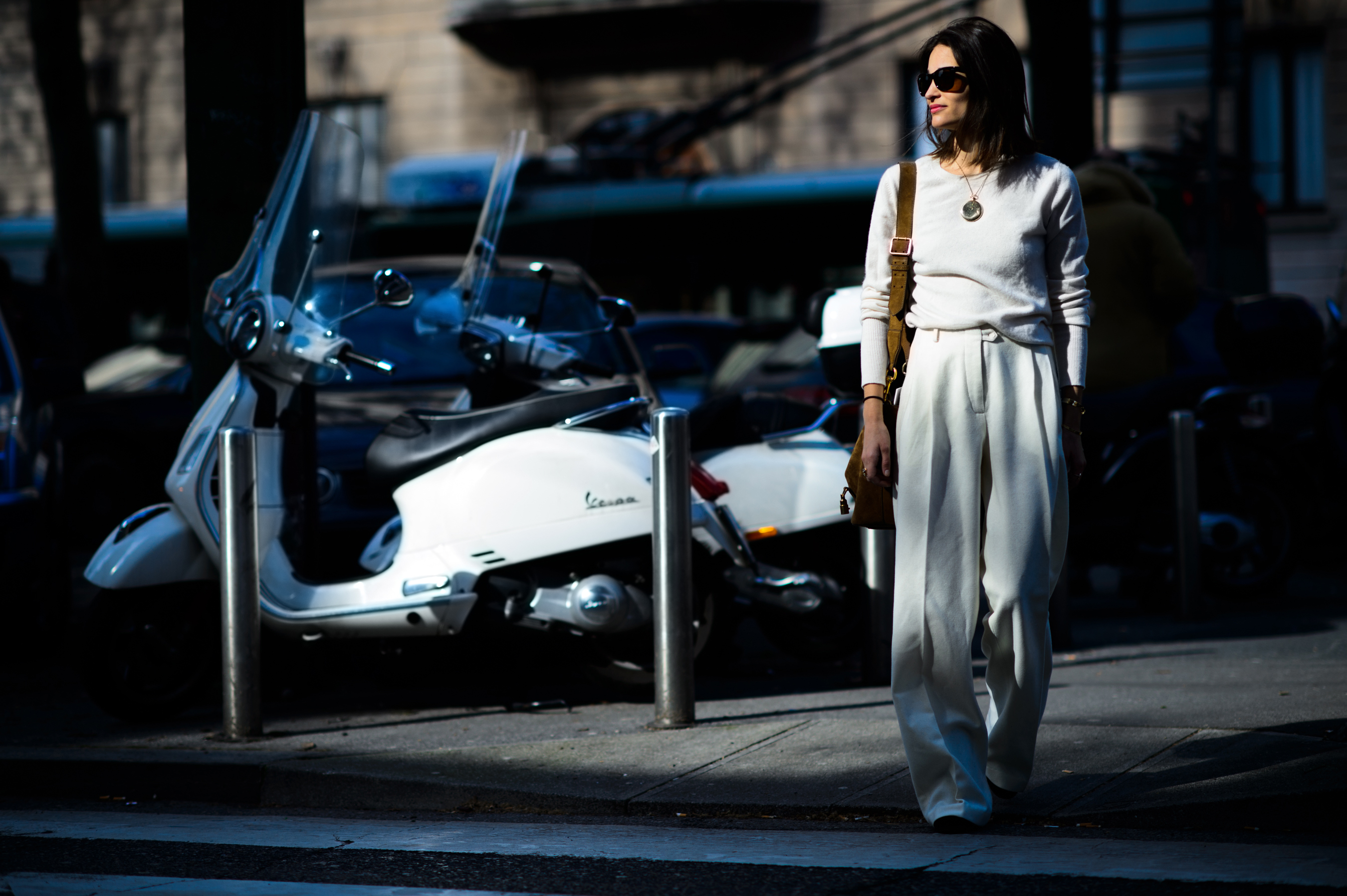 Editor wearing white crossing the road