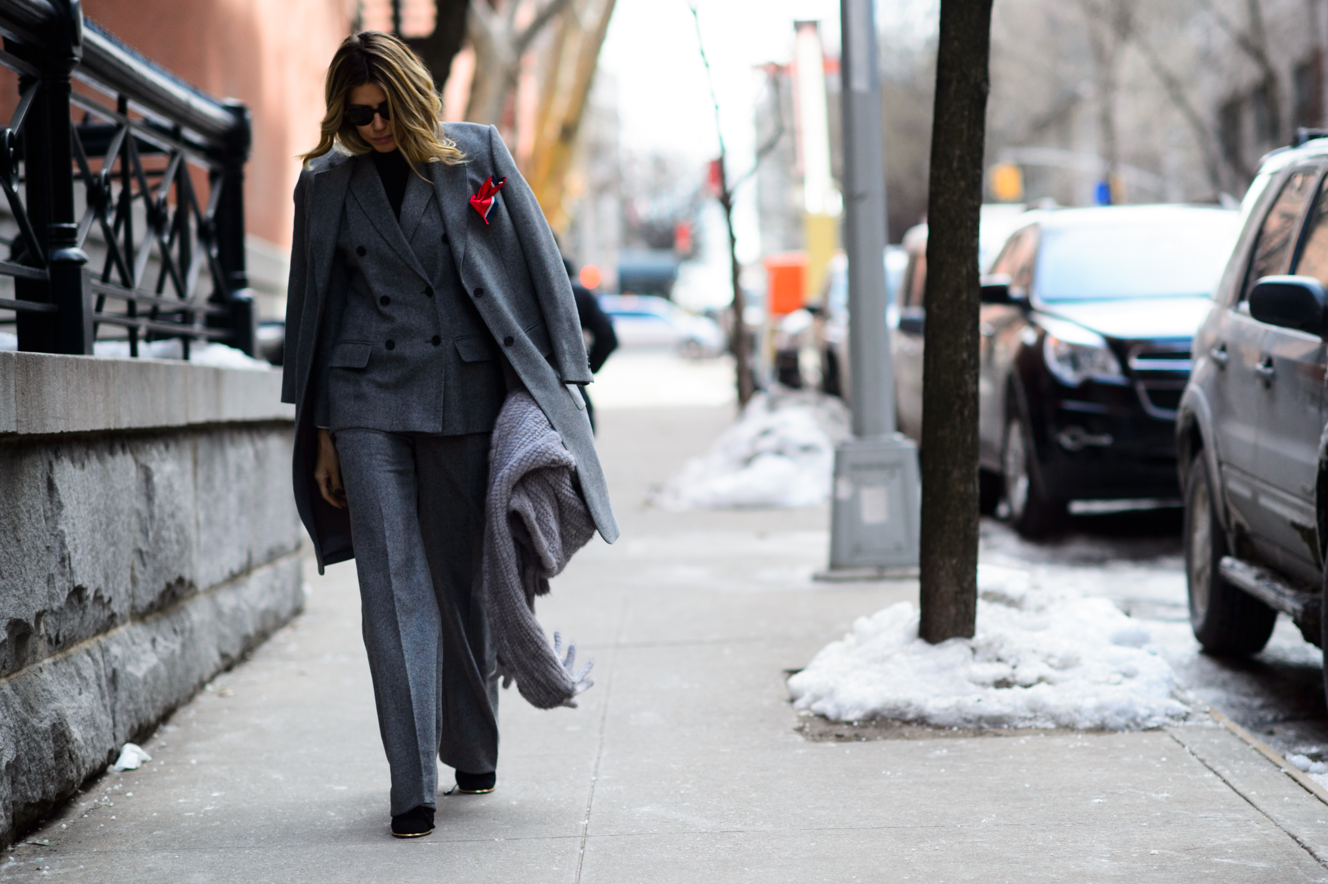 Woman wearing suit and red scarf in front pocket