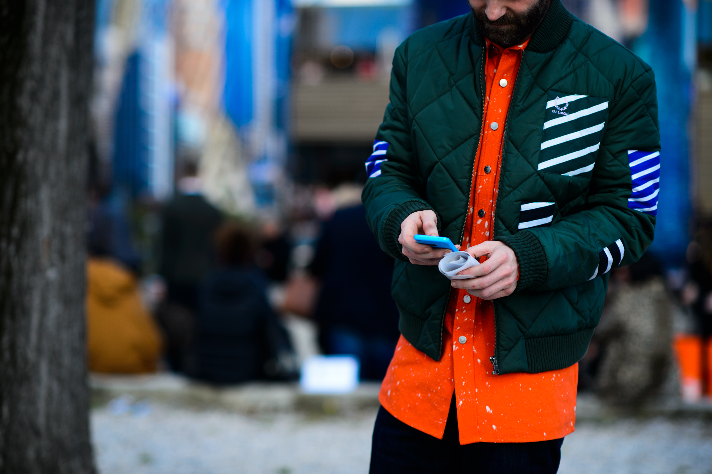 Editor wearing orange shirt and green jacket