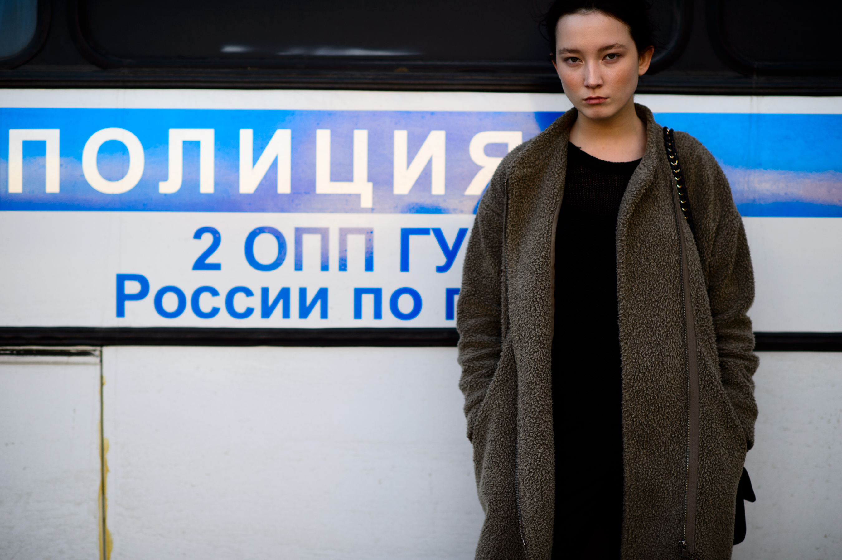 Model in front of police bus after the show