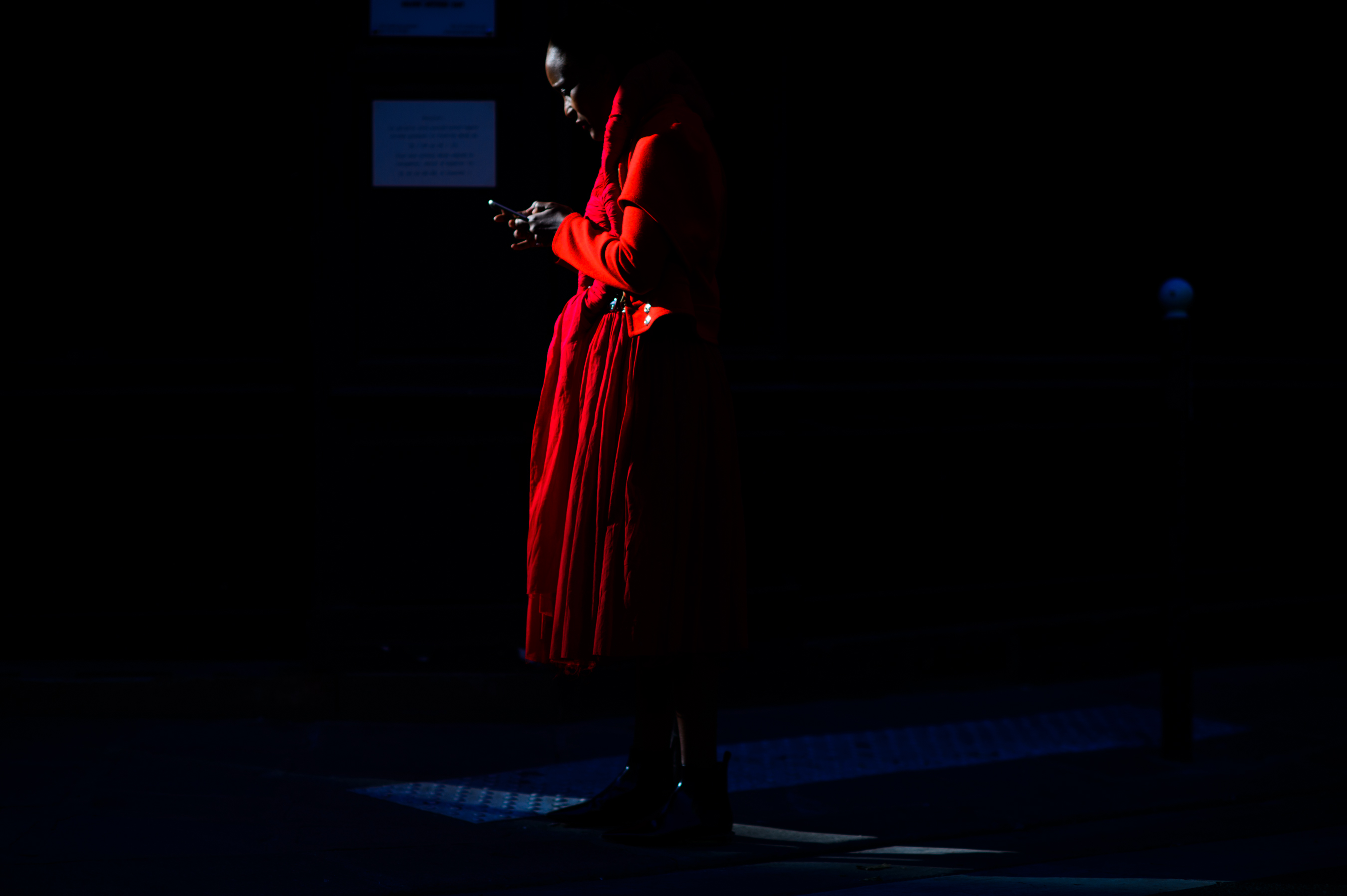 Woman in low light wearing red outfit
