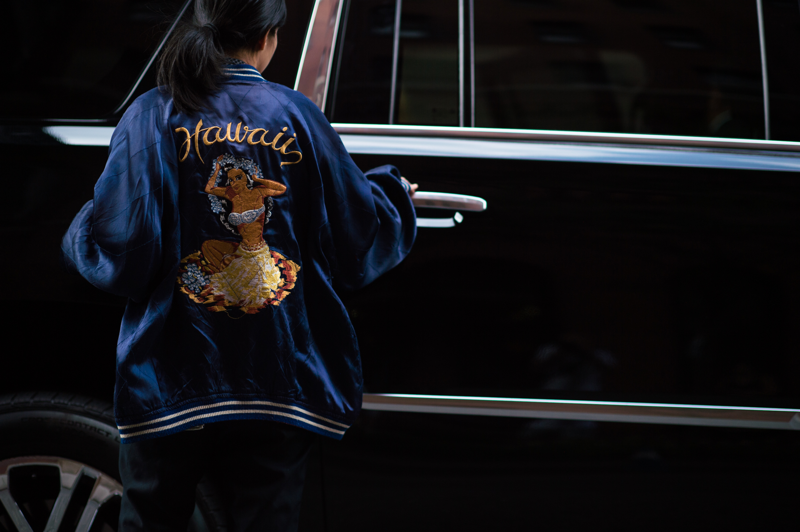 Woman wearing Hawaii bomber jacket