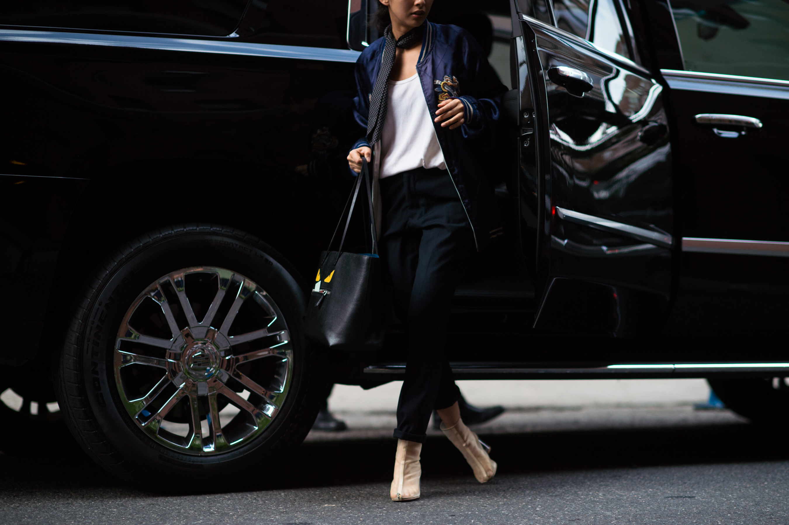 Woman wearing bomber jacket and transparent boots