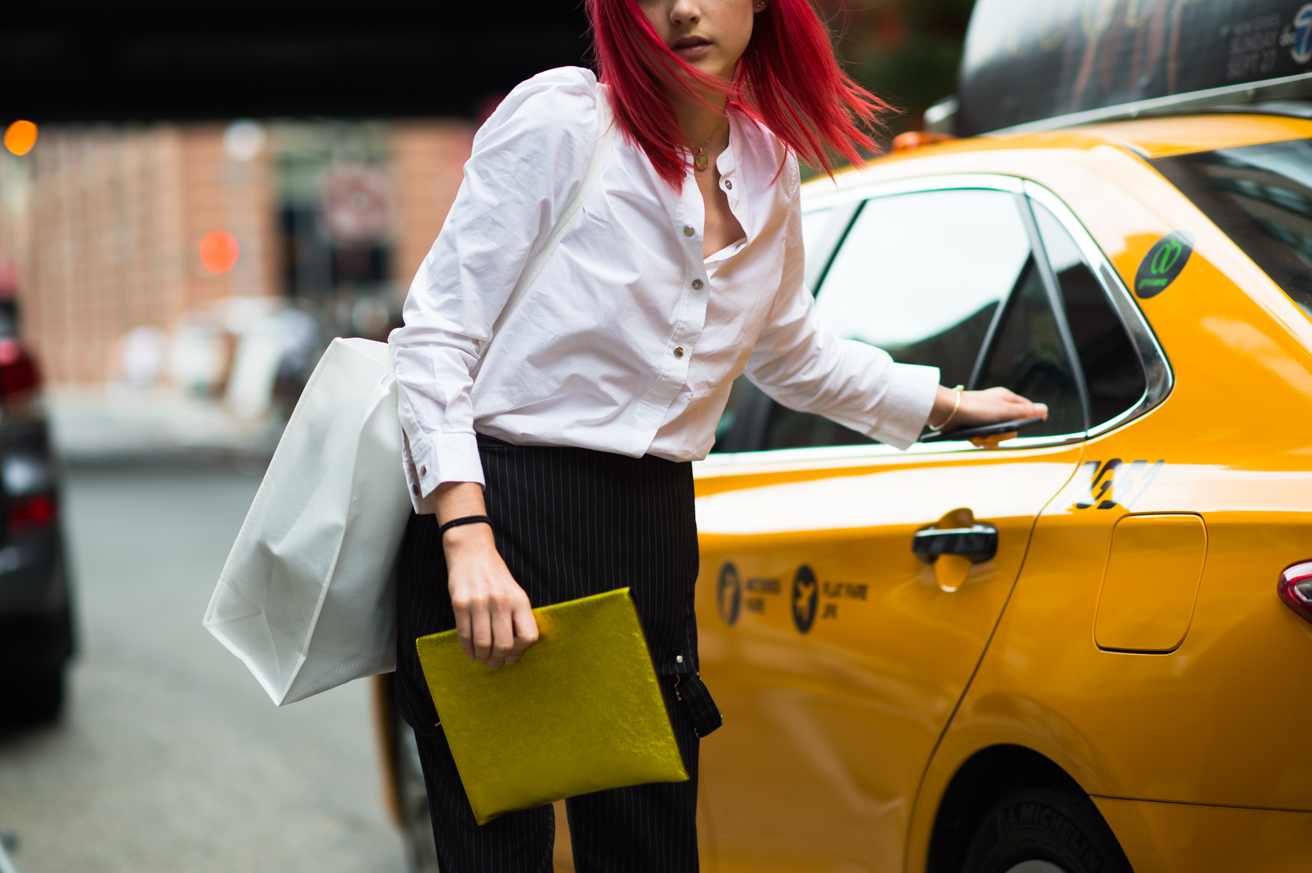 Woman with red hair getting out of the taxi