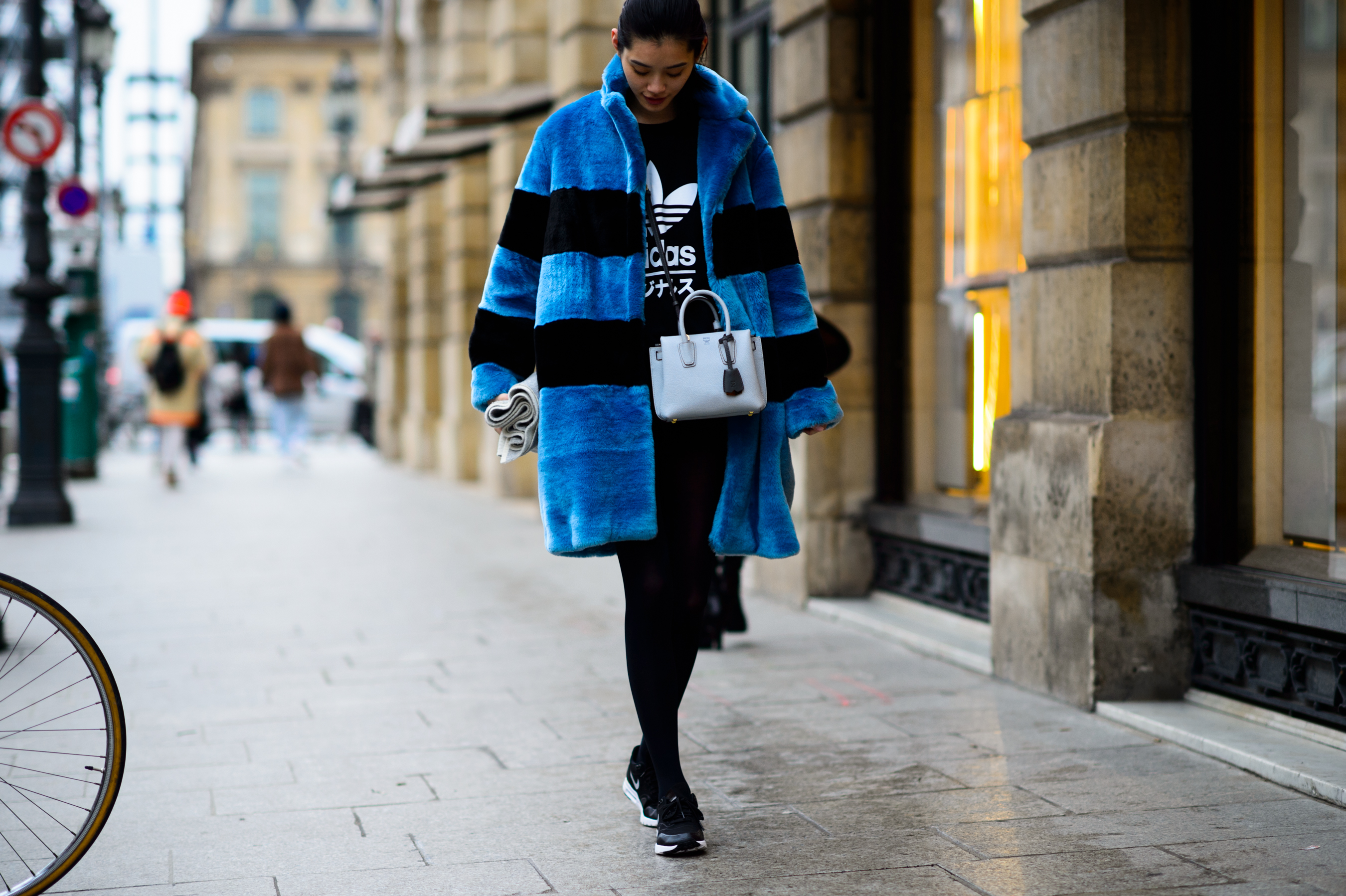 Asian model wearing blue warm coat after Schiaparelli
