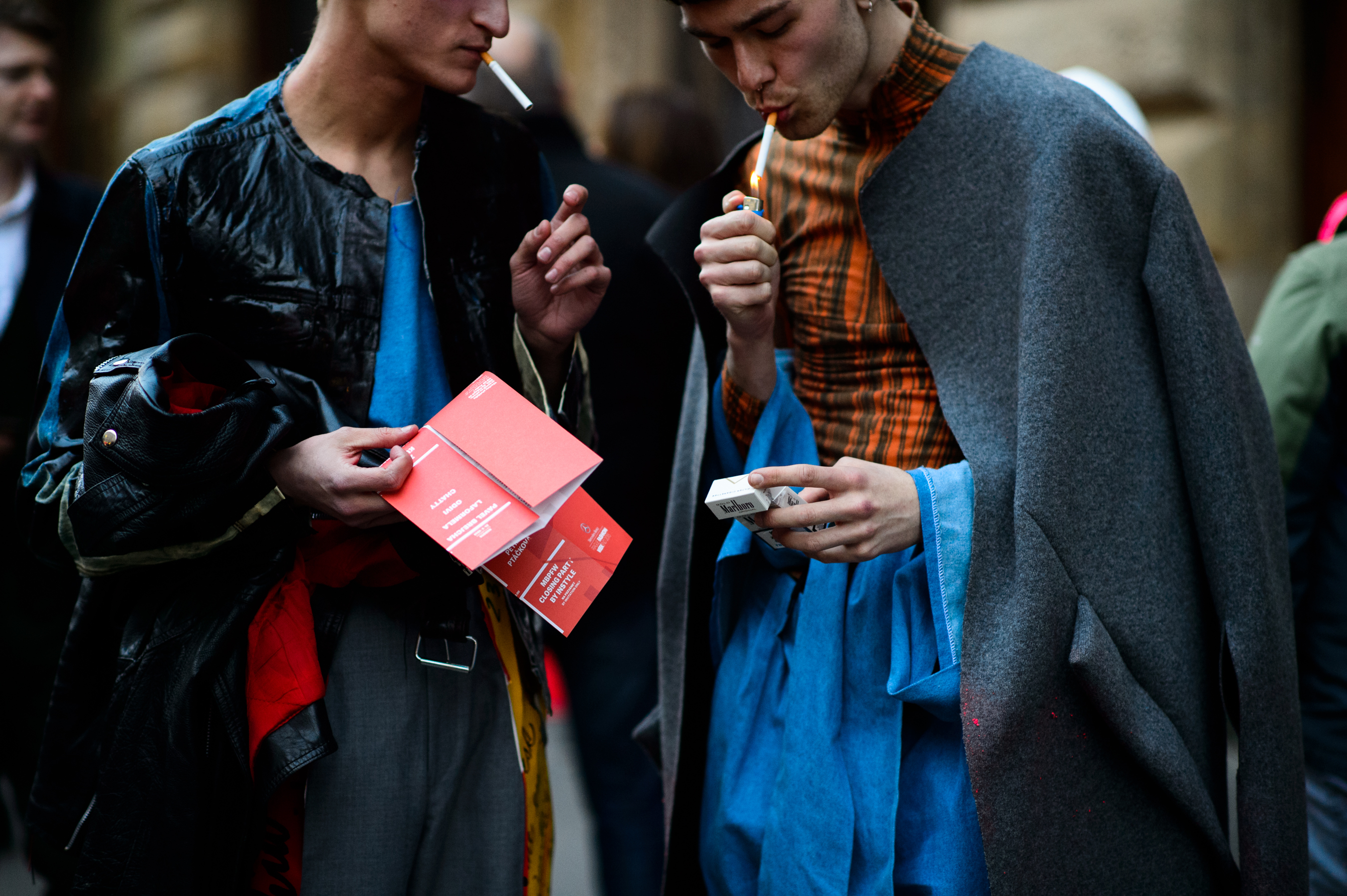 Two men lighting a cigarette