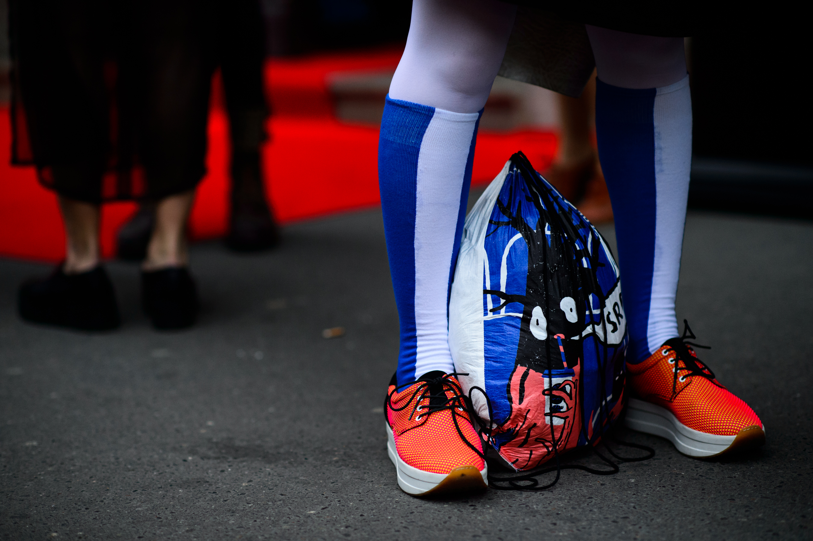 Man wearing blue socks with orange sneakers