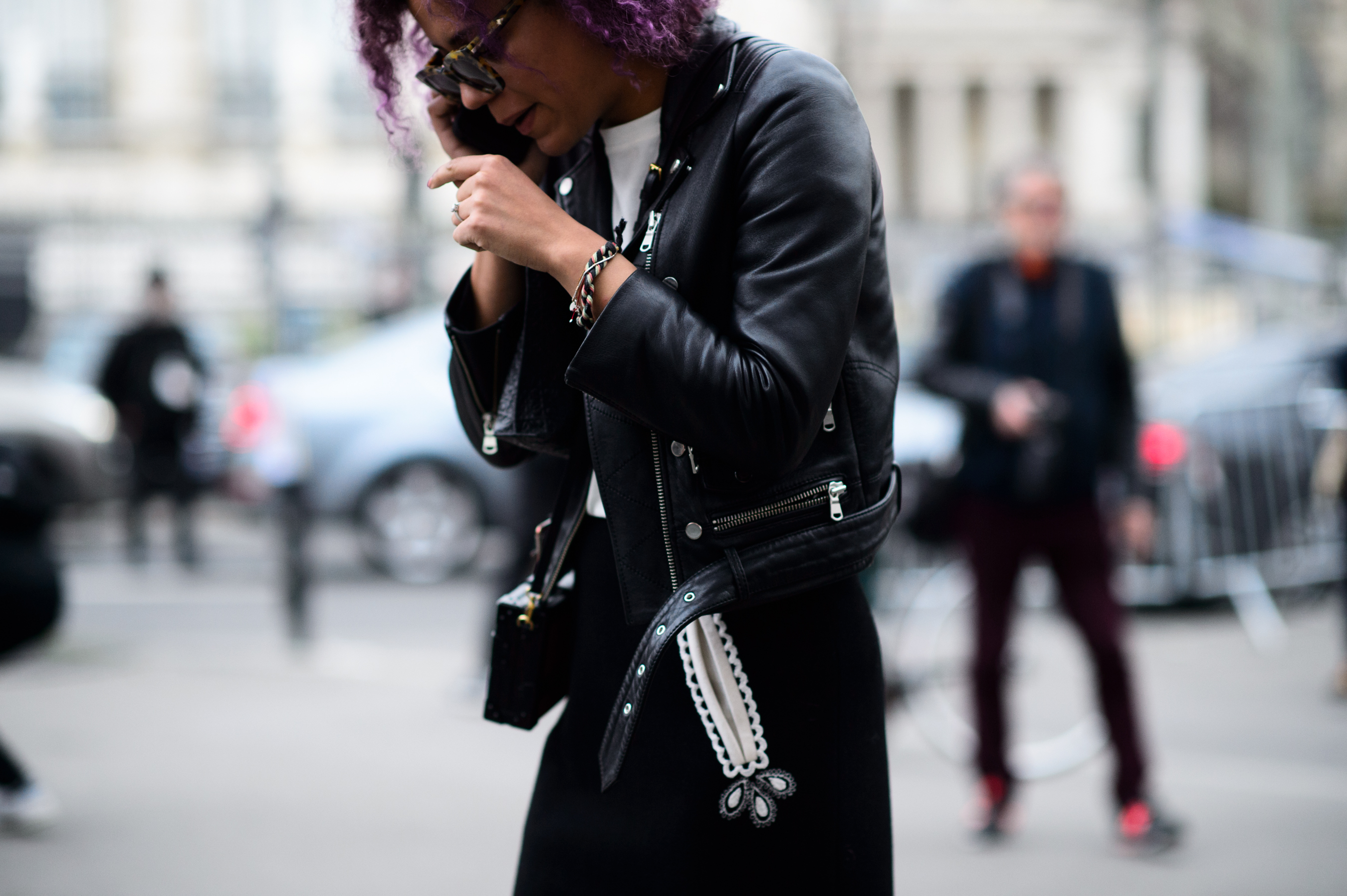 Stylist with purple hair wearing leather jacket