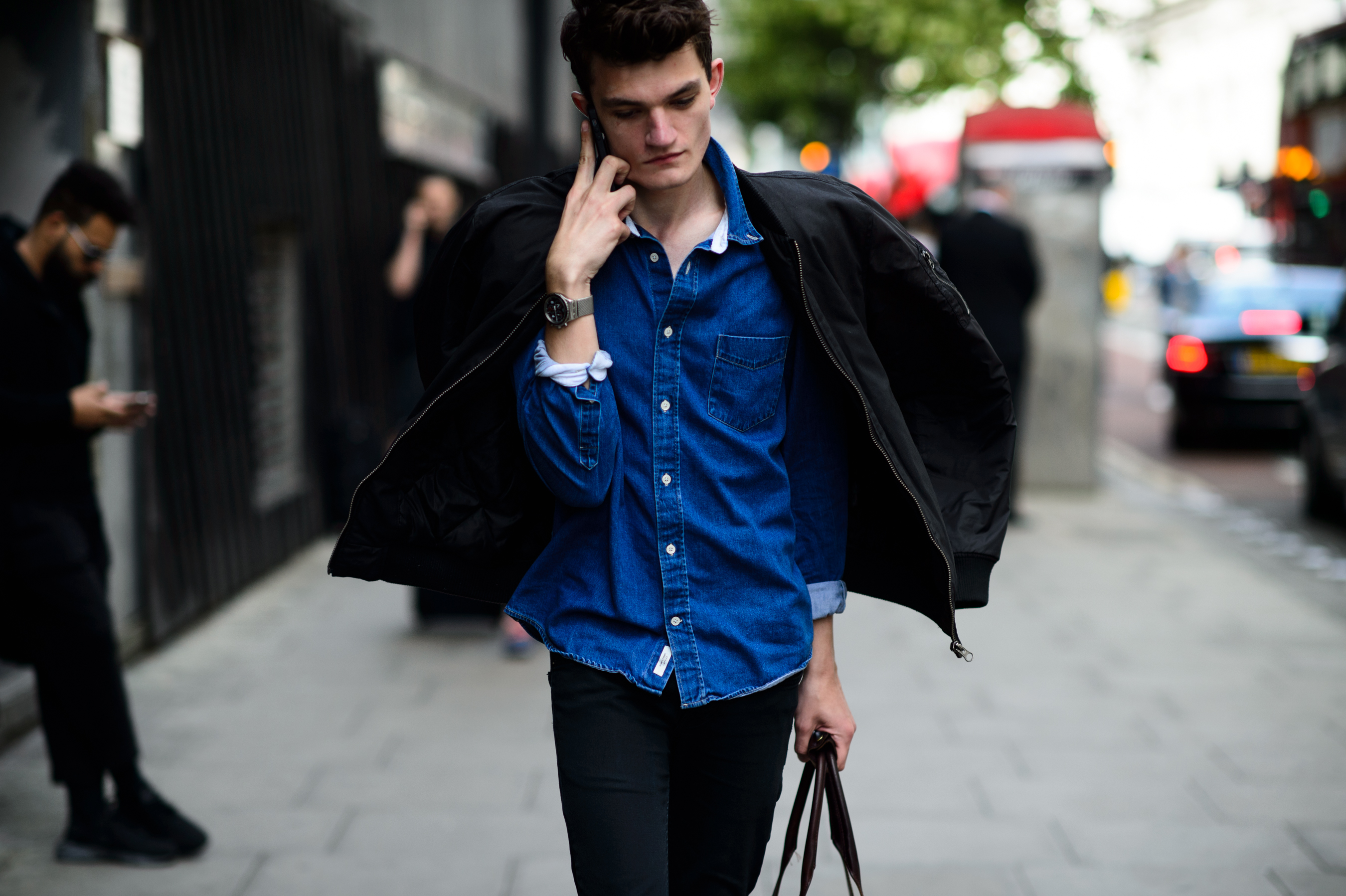 Male model in denim shirt after the show