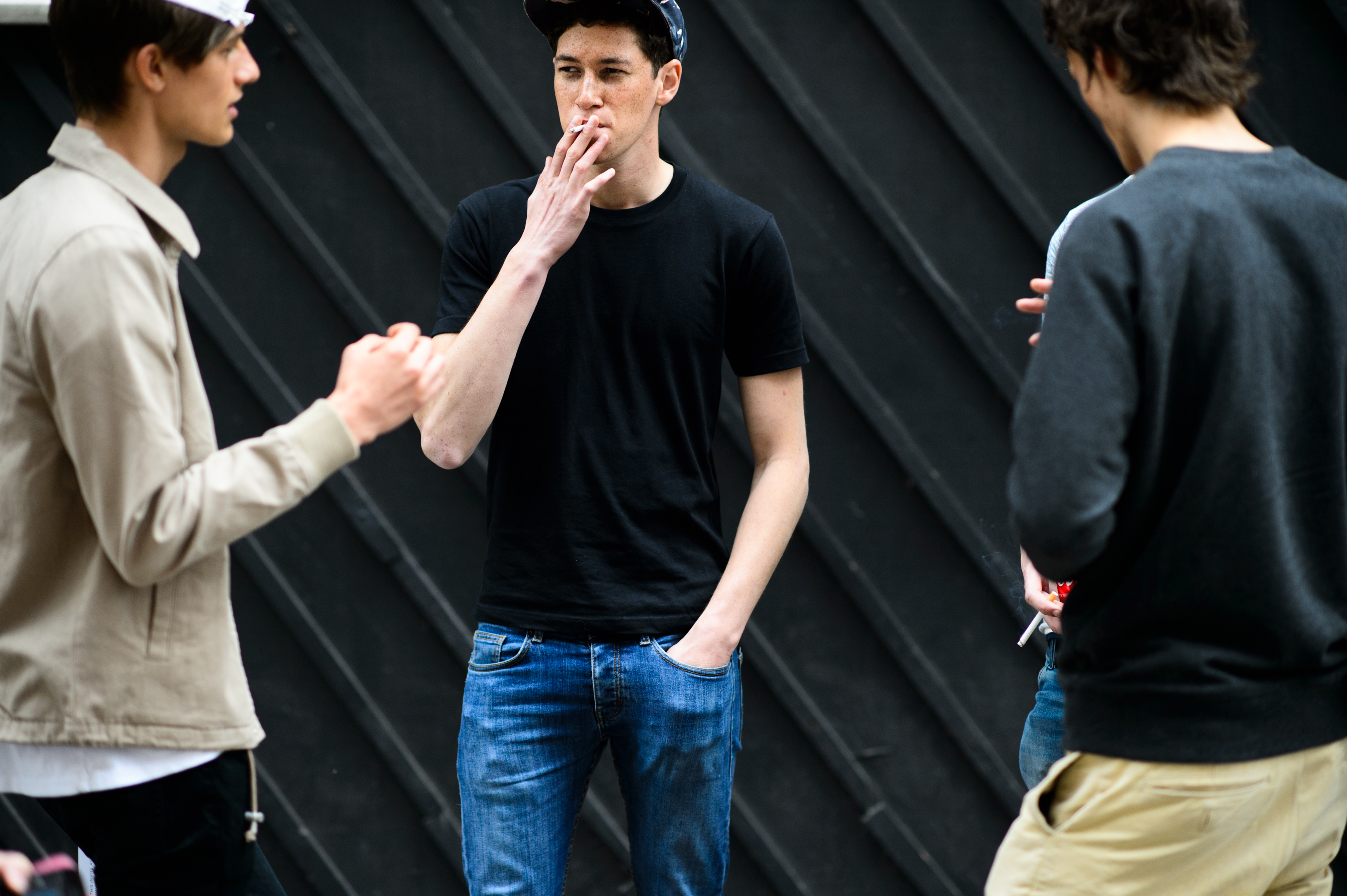 Three male models after the show