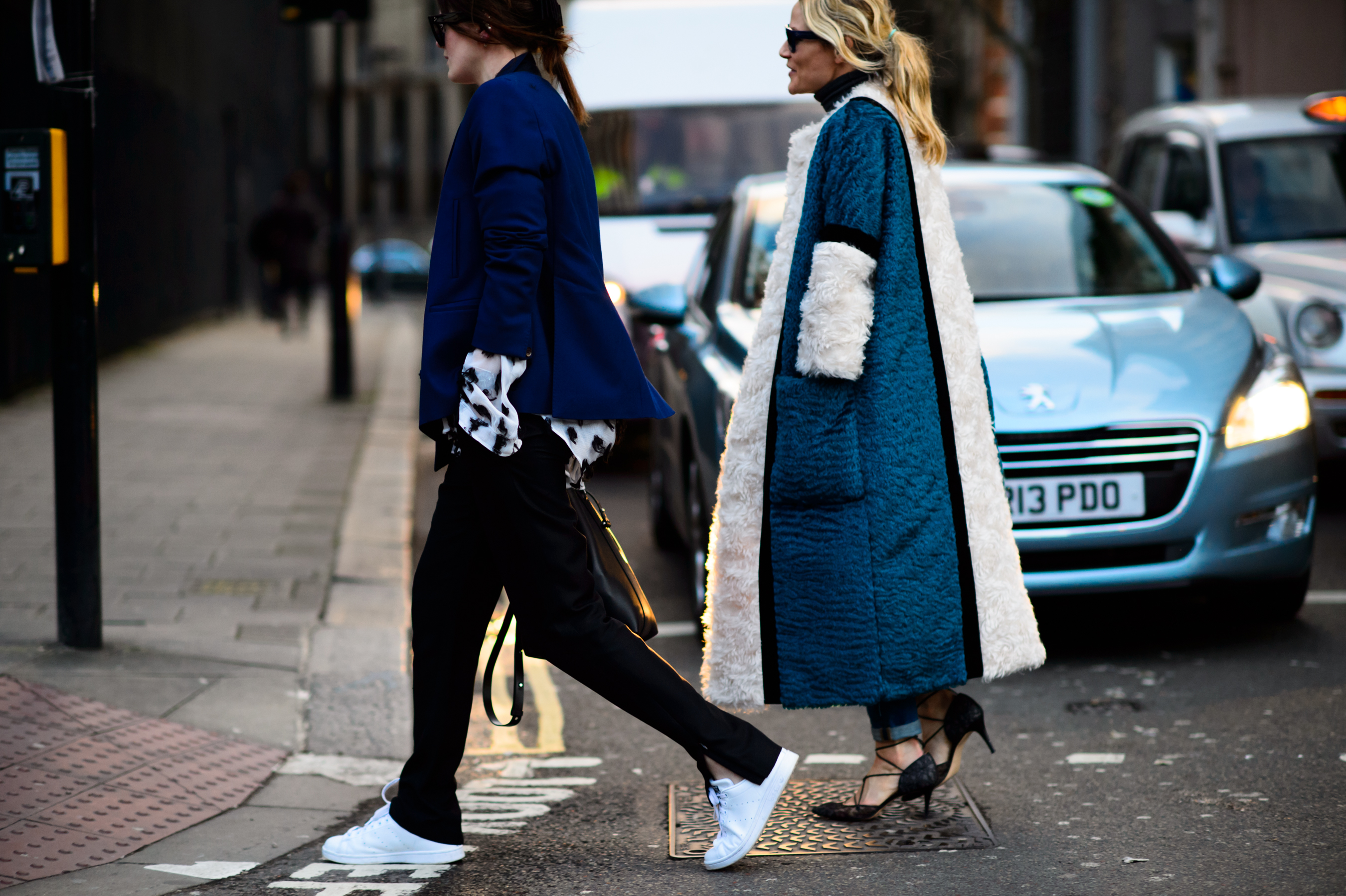 Two women in blue crossing the road