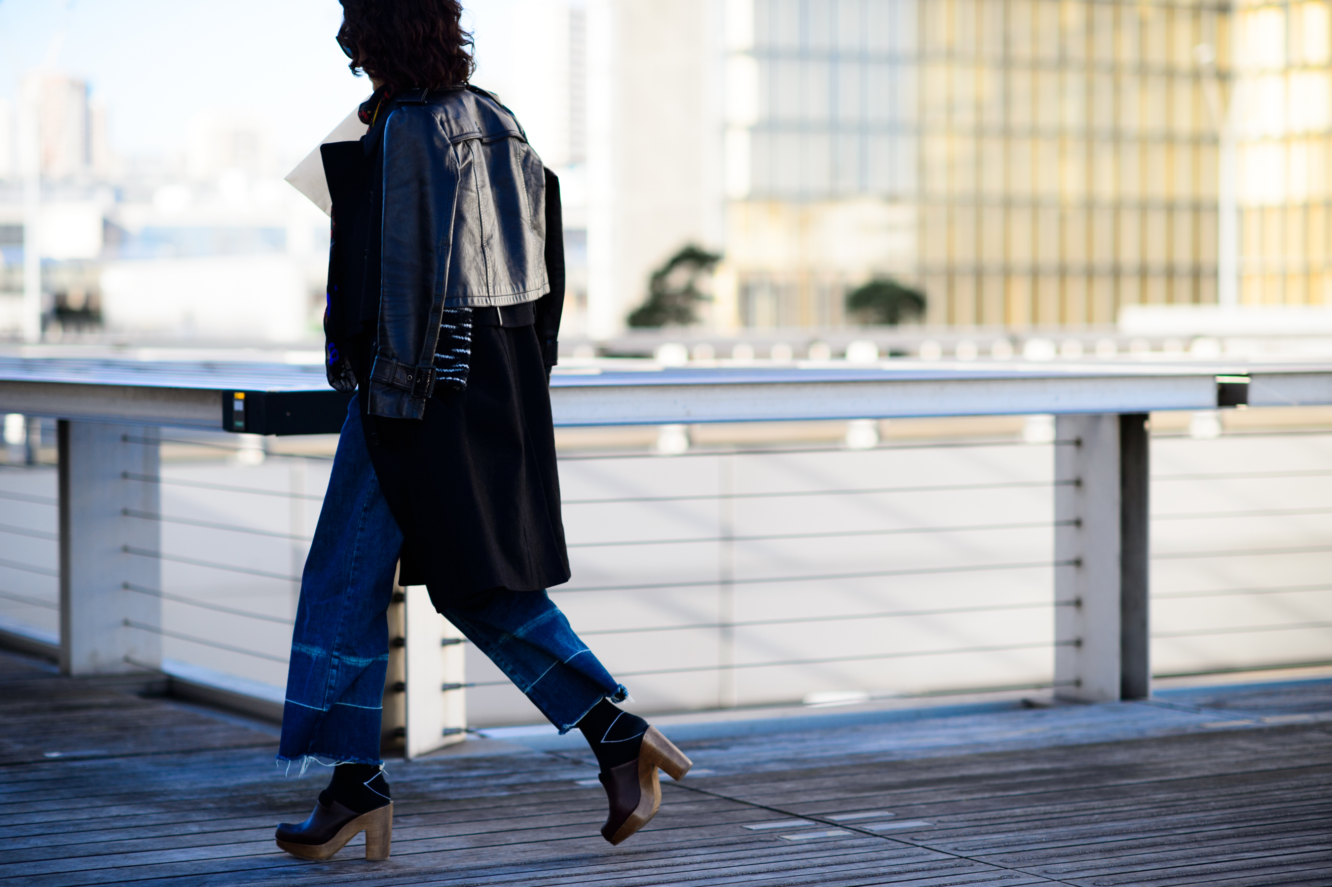 Editor wearing leather jacket and wide jeans