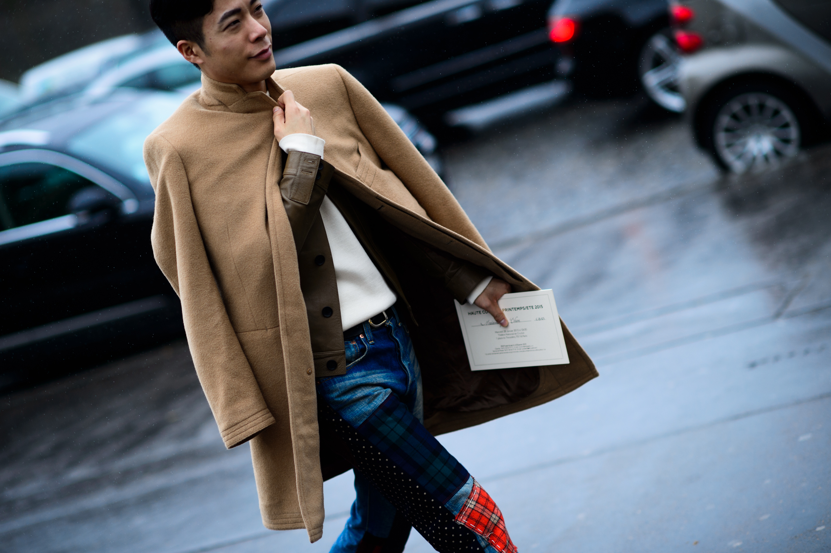 Asian man wearing camel coat before the show