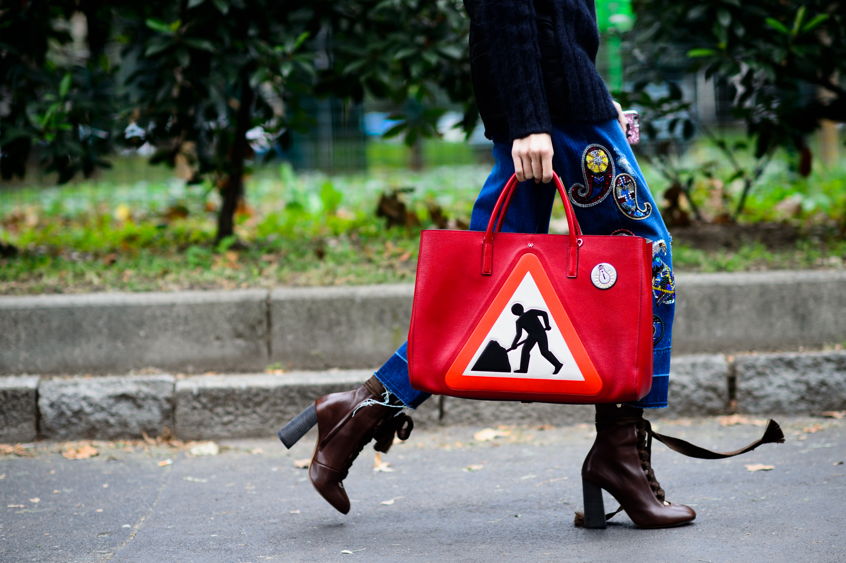 Store owner with red bag with roadsign