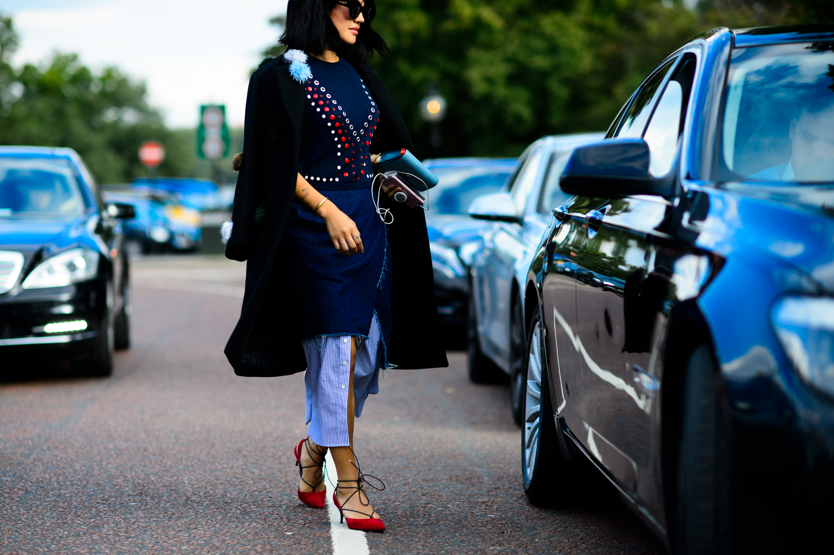 Woman wearing red sandals and long shirt dress