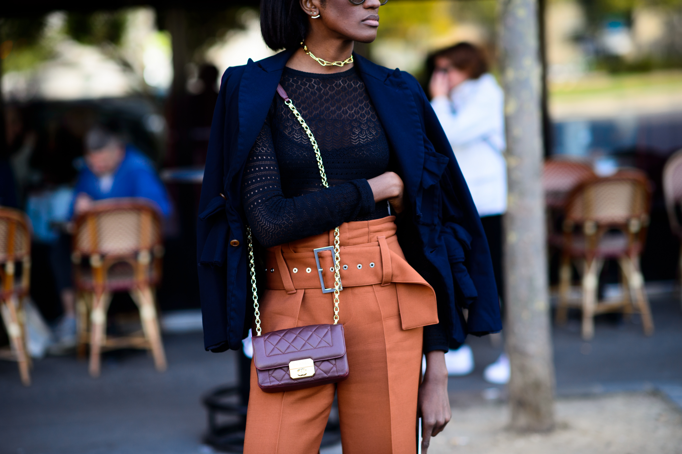 Woman in orange suit pants with wide belt