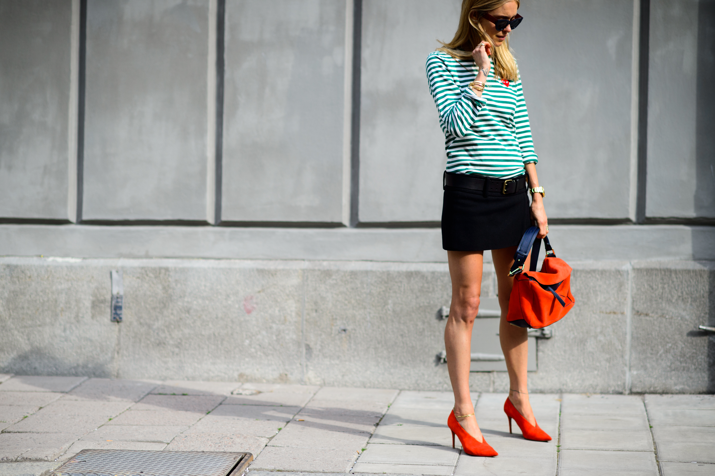 Danish blogger in mini skirt and orange accessories