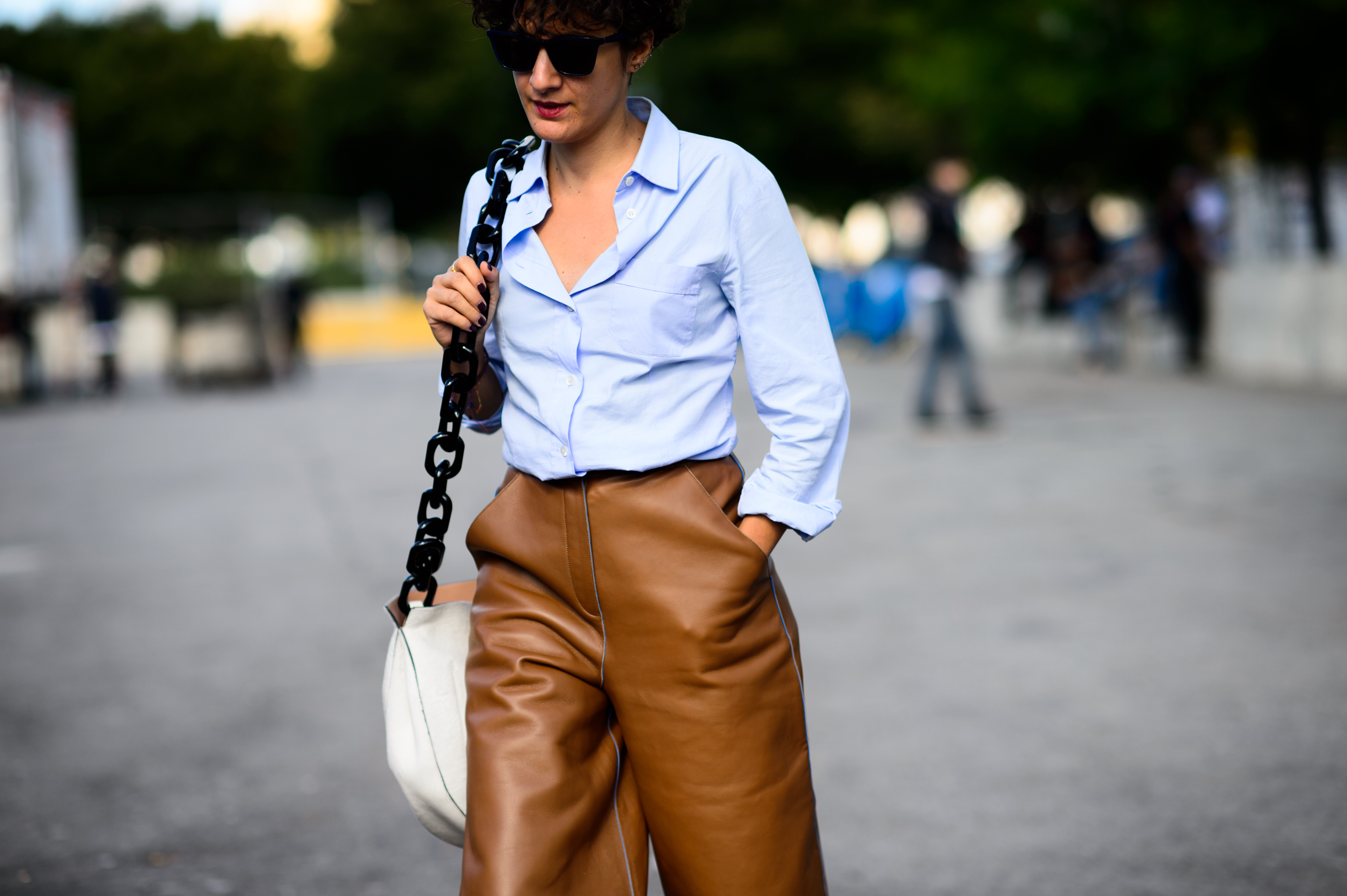 Woman wearing leather pants and blue shirt