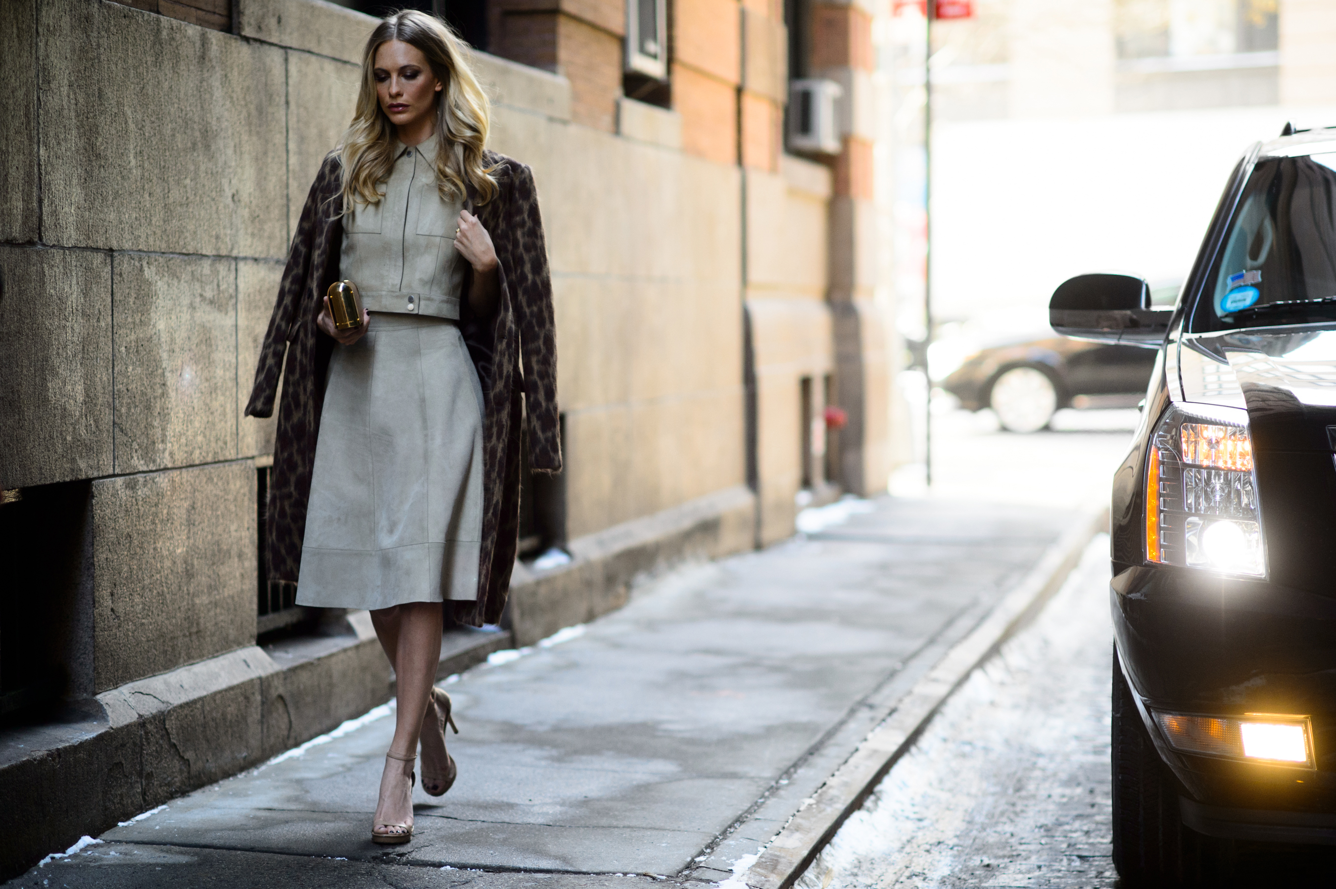 Blonde British woman wearing suede outfit