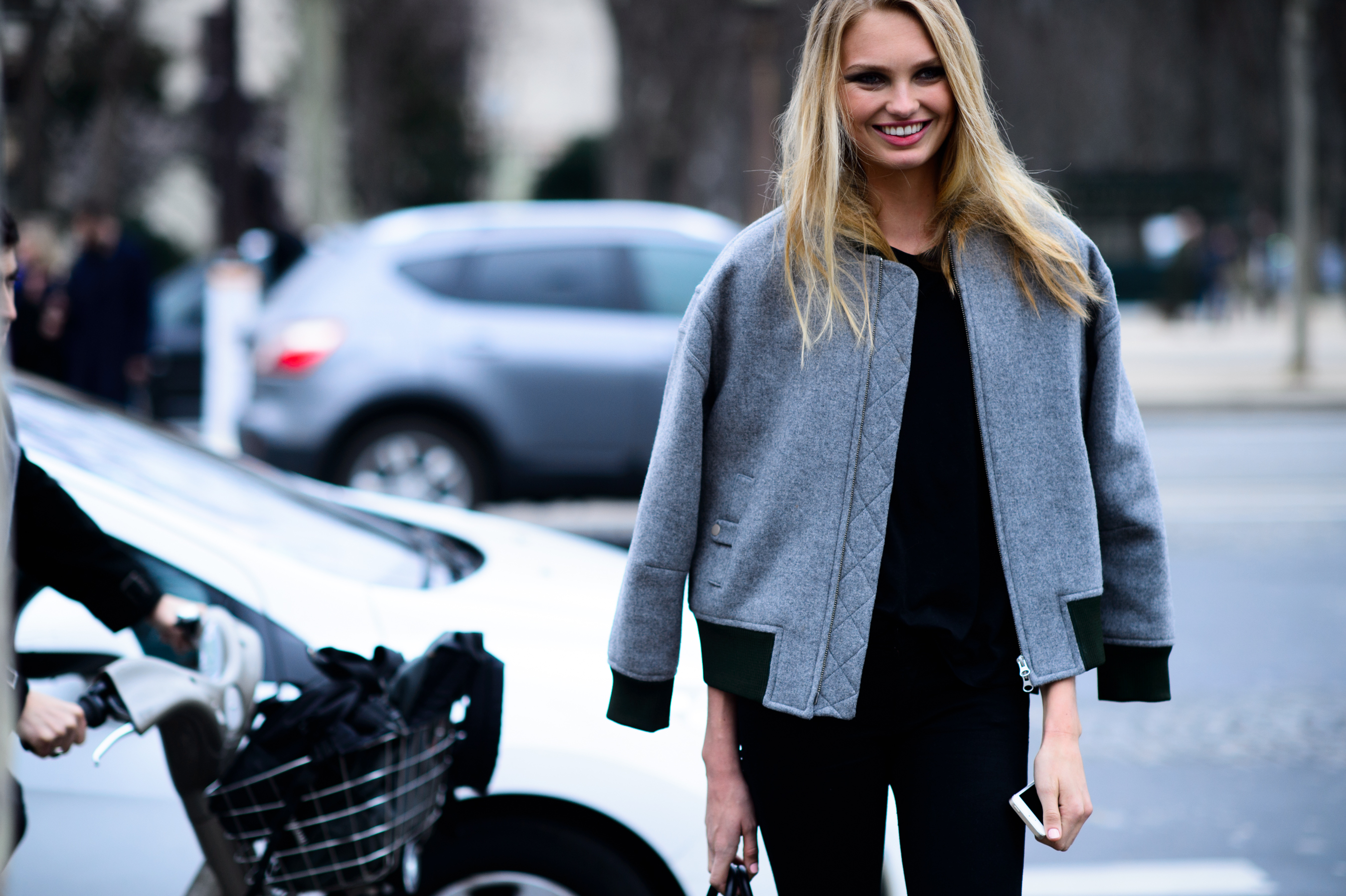 Blonde model wearing grey bomber