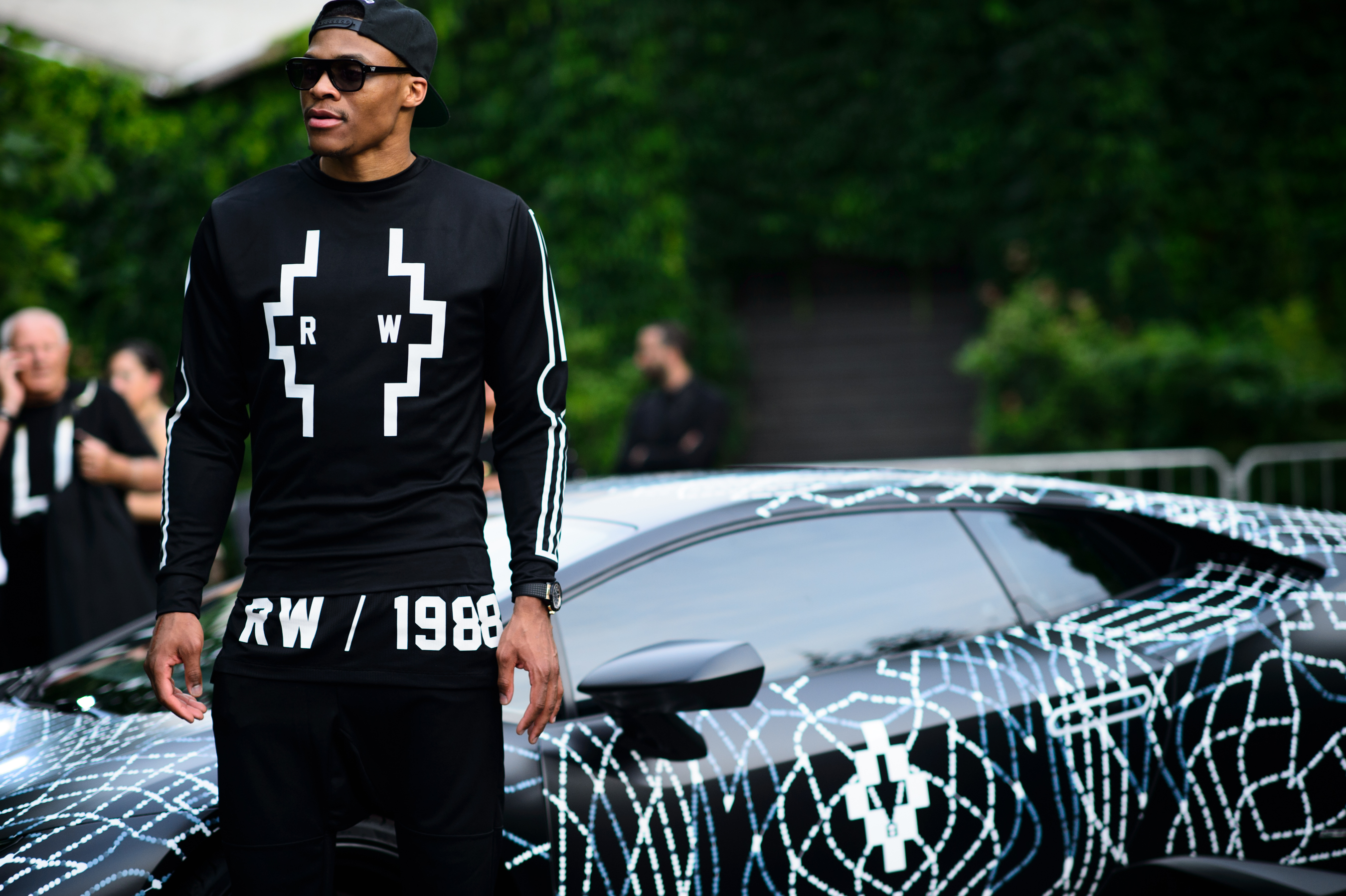 Basketball player in front of the car
