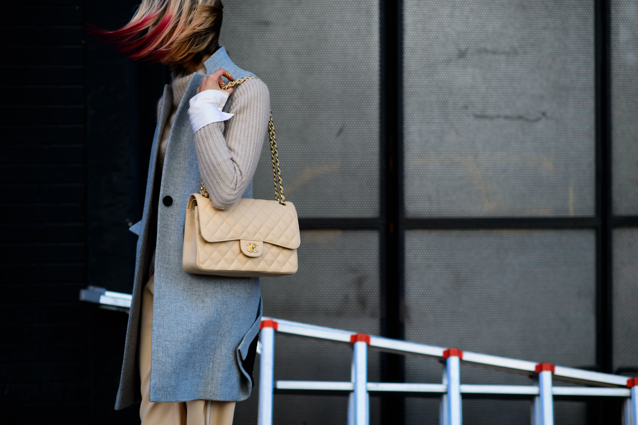 Blogger with pink hair with grey vest