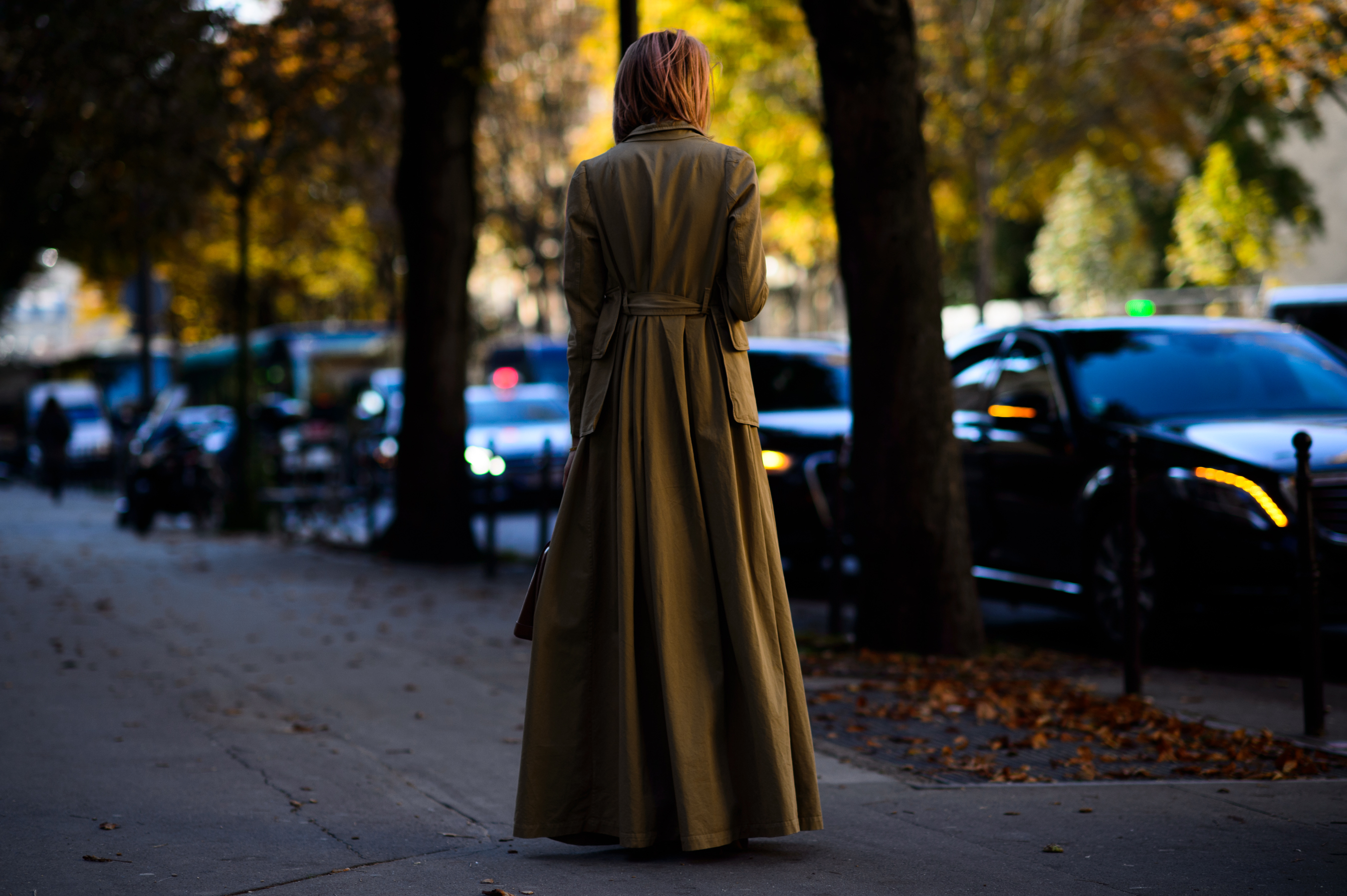 American blogger wearing long brown coat