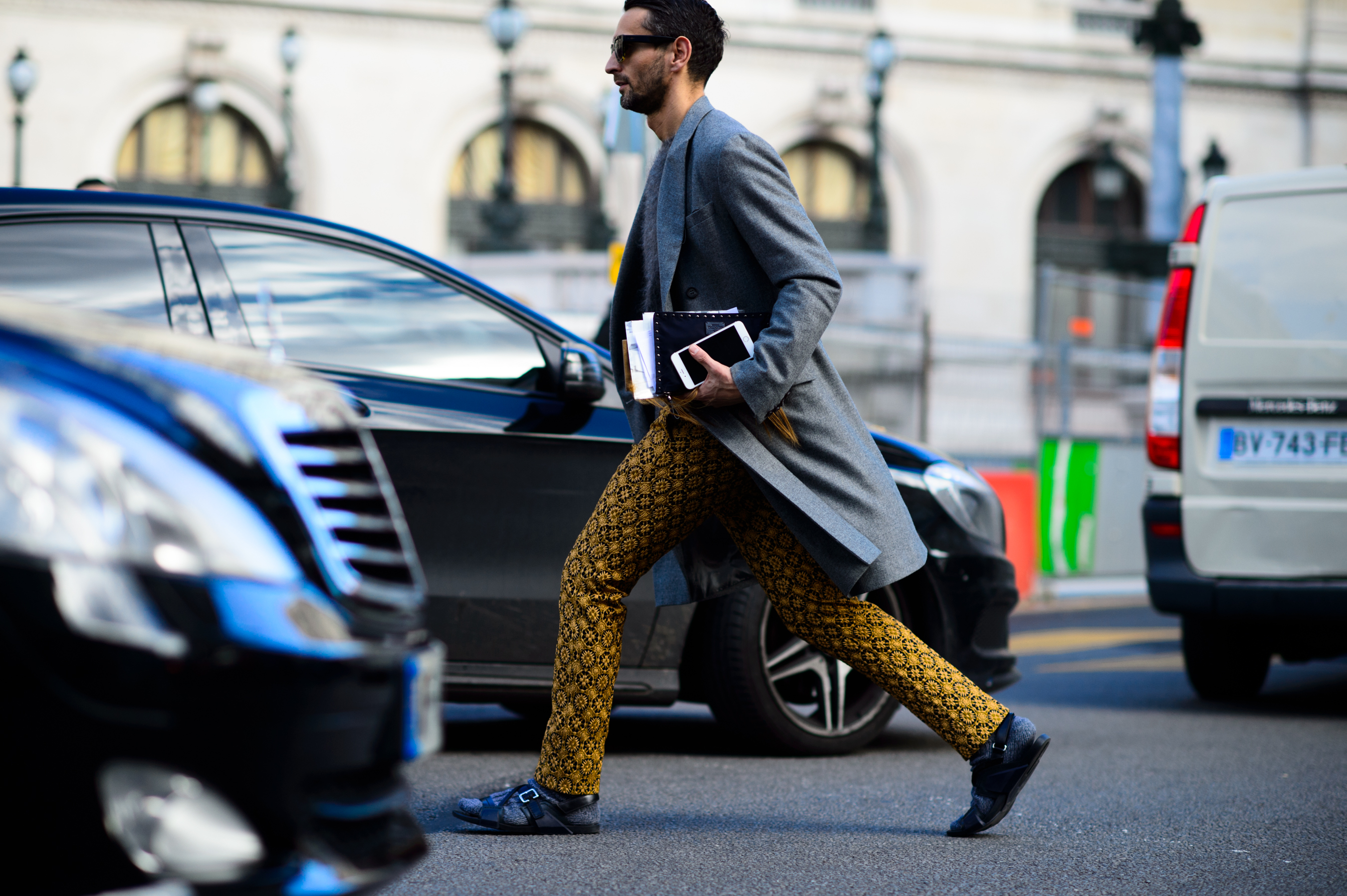Italian journalist wearing printed pants and grey coat