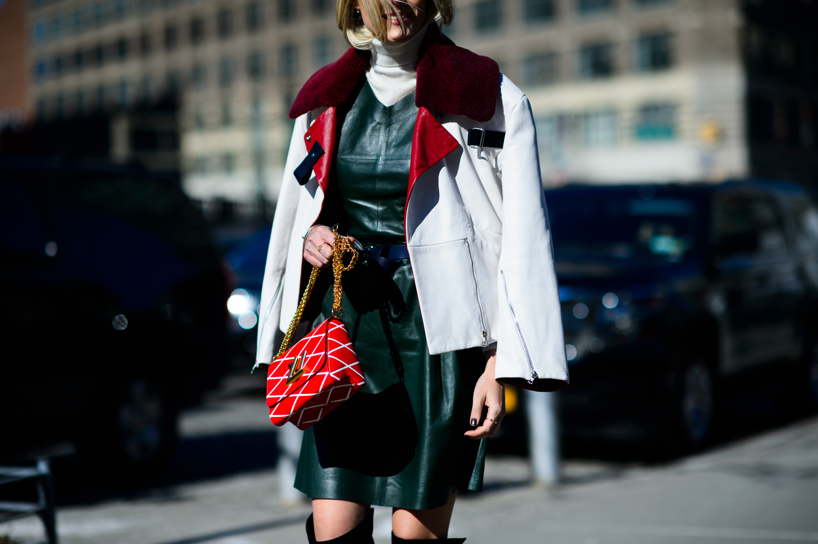 Blogger in white leather jacket crossing the road