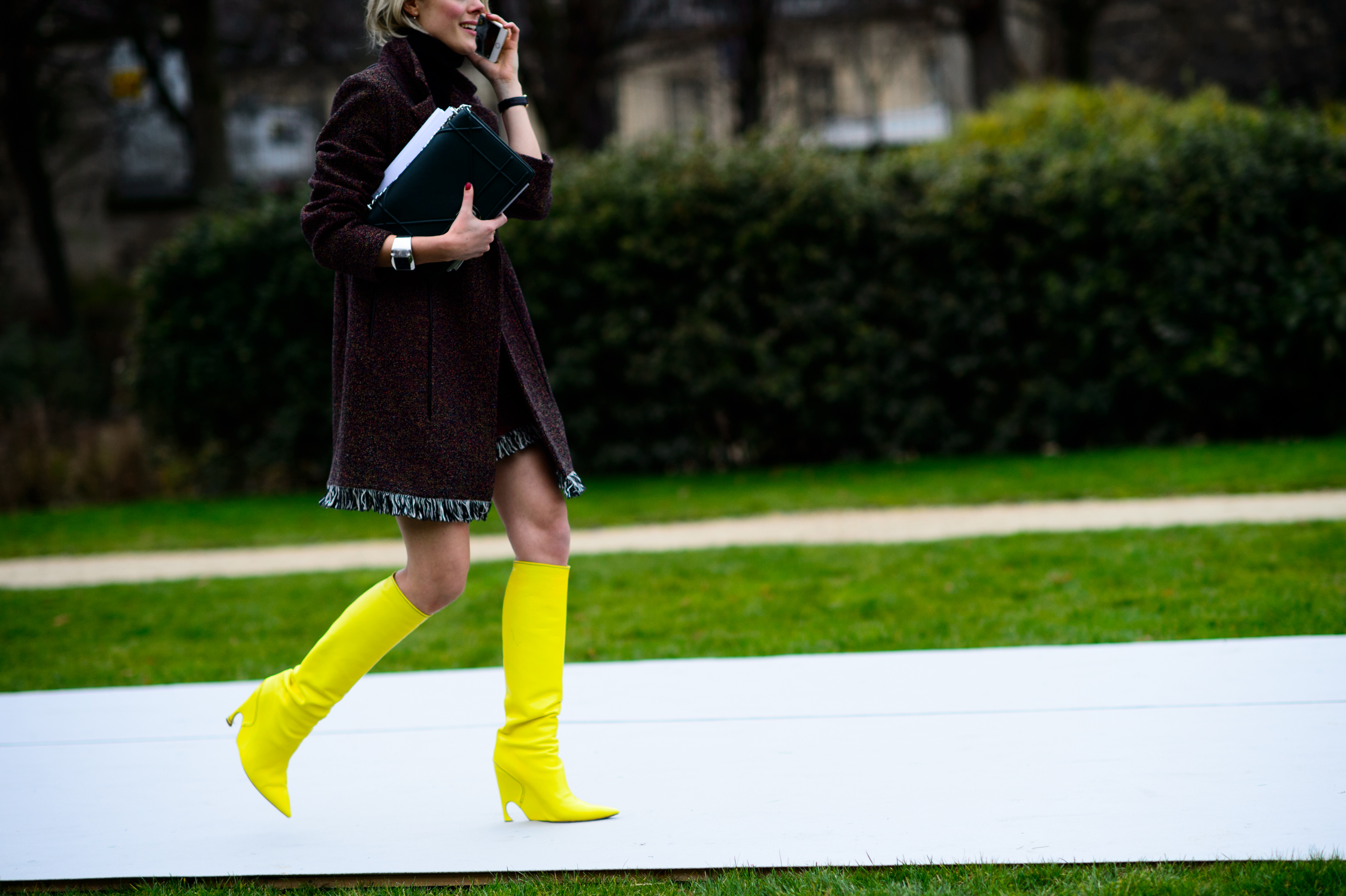 Blogger wearing tall yellow Dior boots