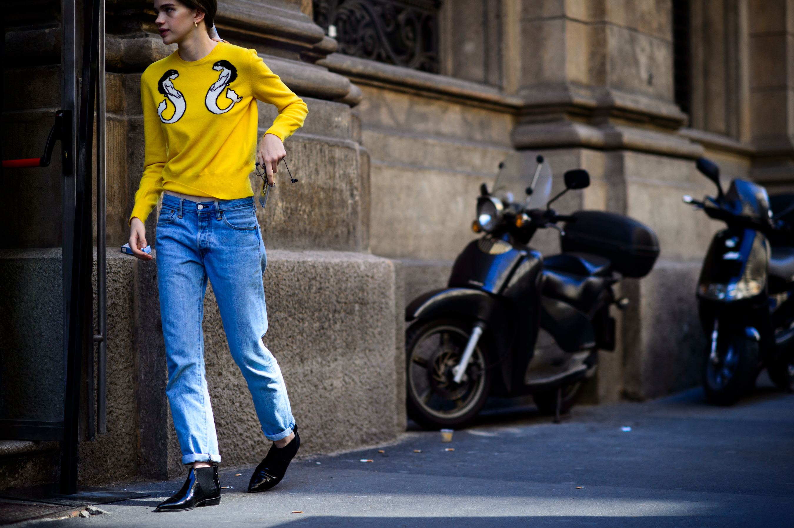 Model wearing yellow sweater after the show