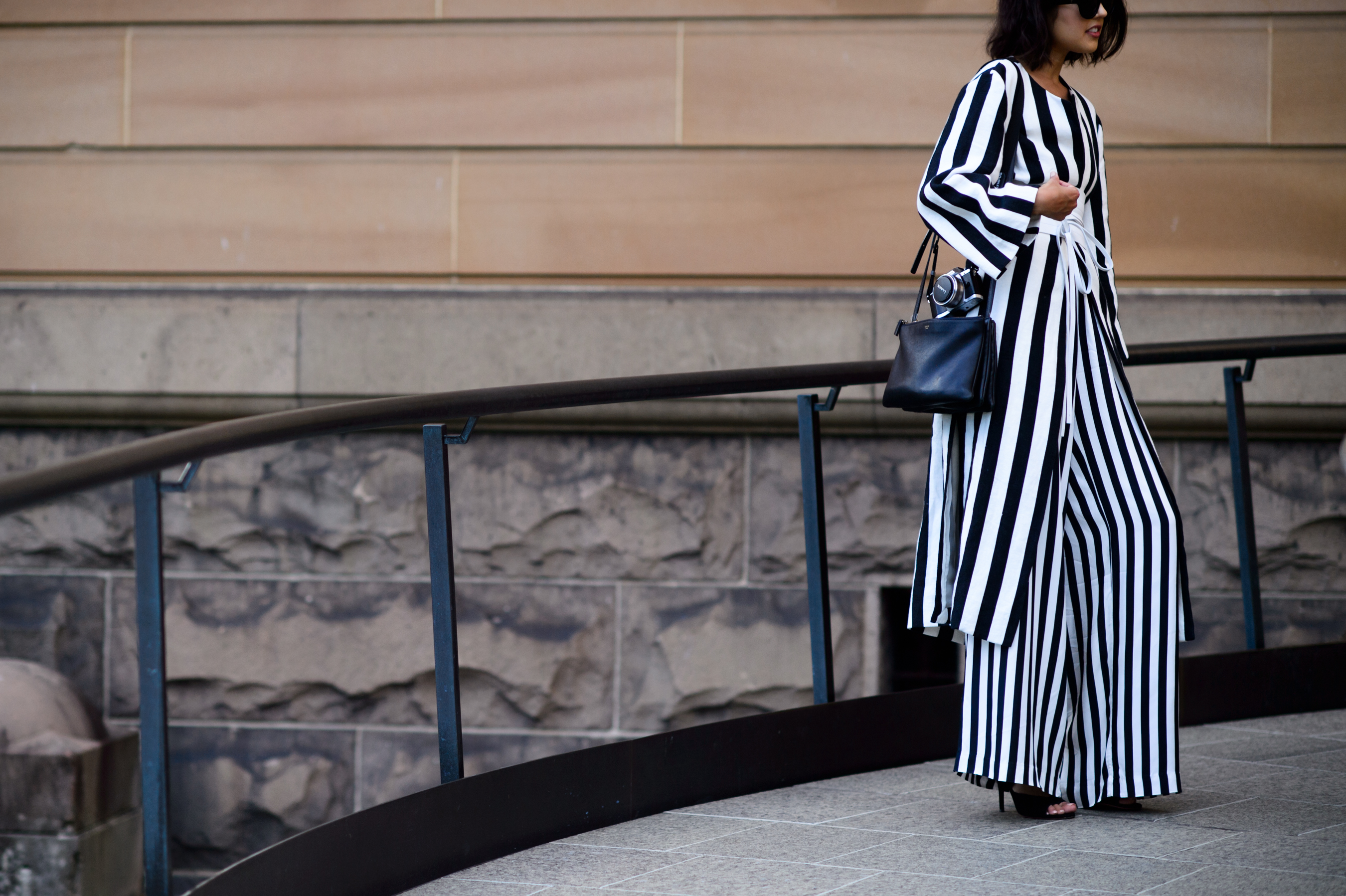 Woman dressed in suit with wide black and white stripes