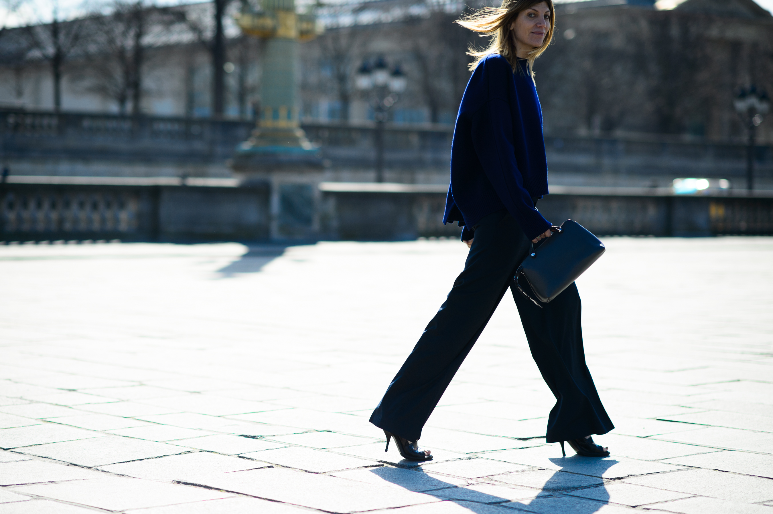 Woman wearing blue sweater and wide pants