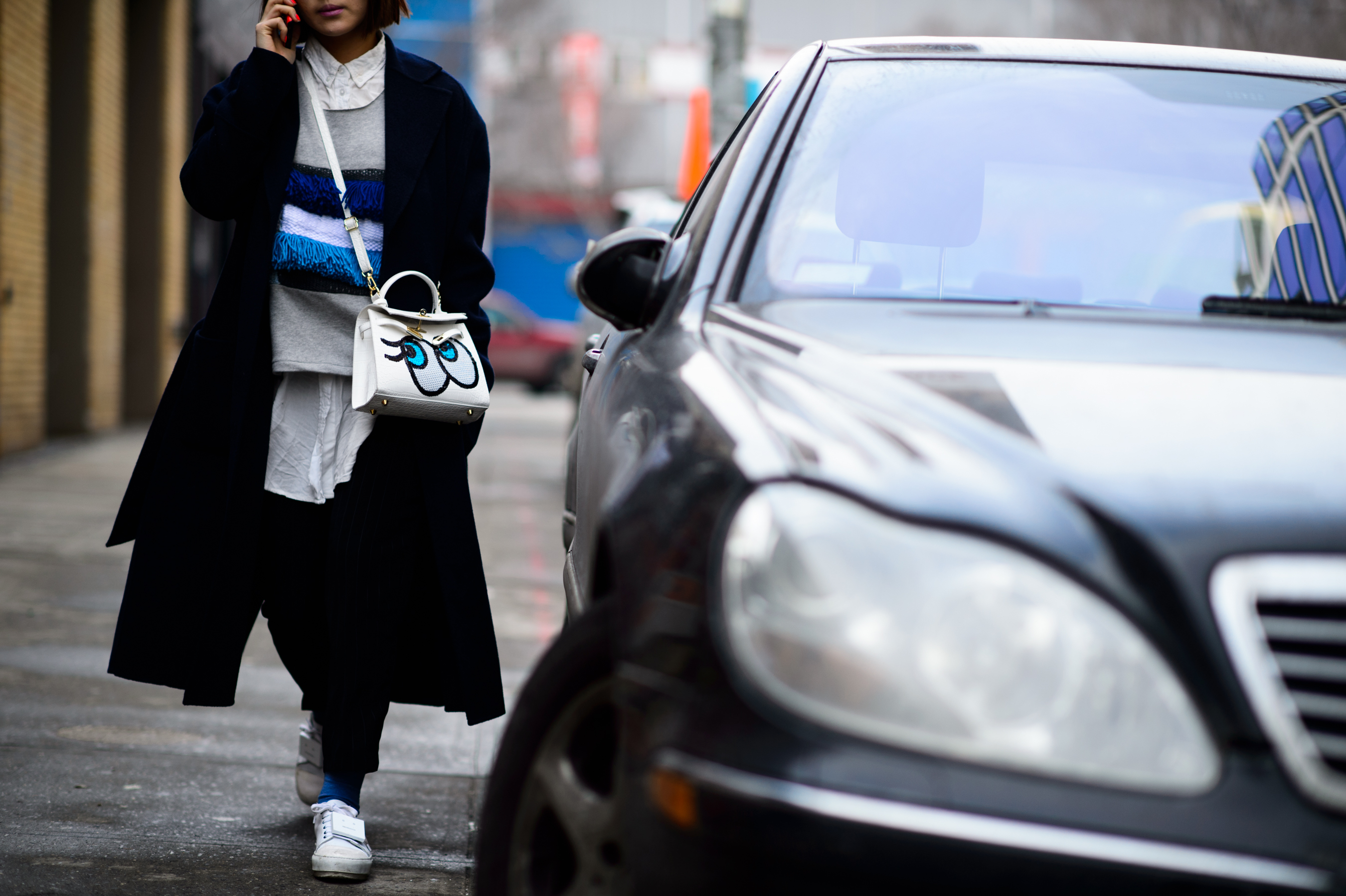 Woman holding bag with eyes