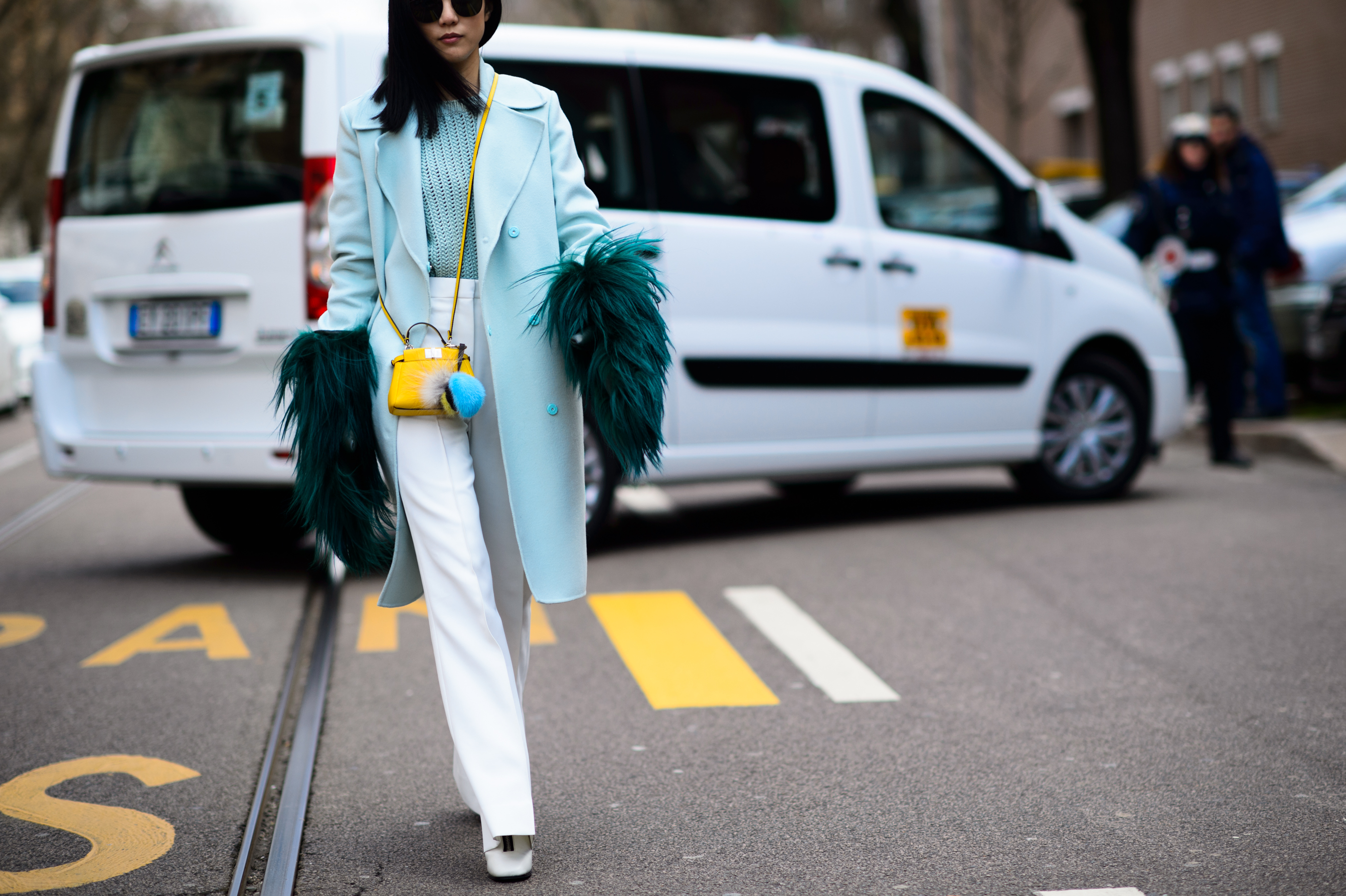 Singaporean journalist wearing blue coat and furry mittens