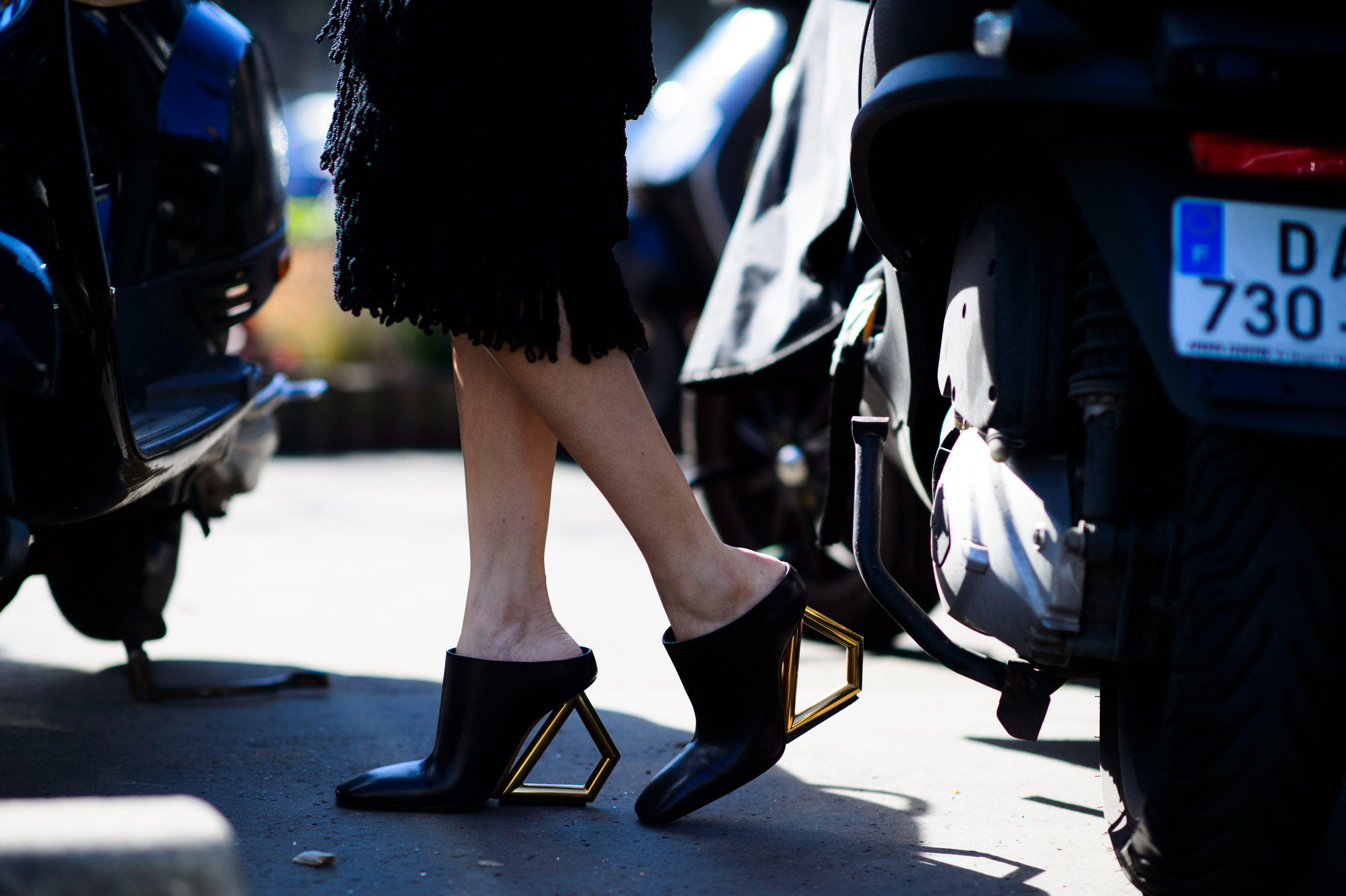 Close up of shoes with geometric heels