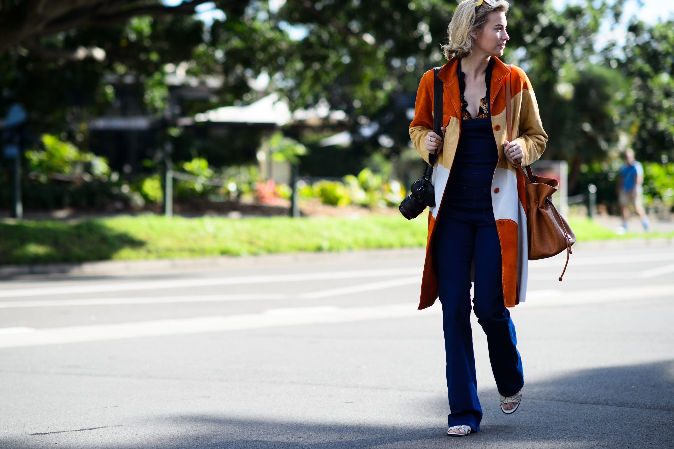 Australian photographer wearing orange coat and bucket bag