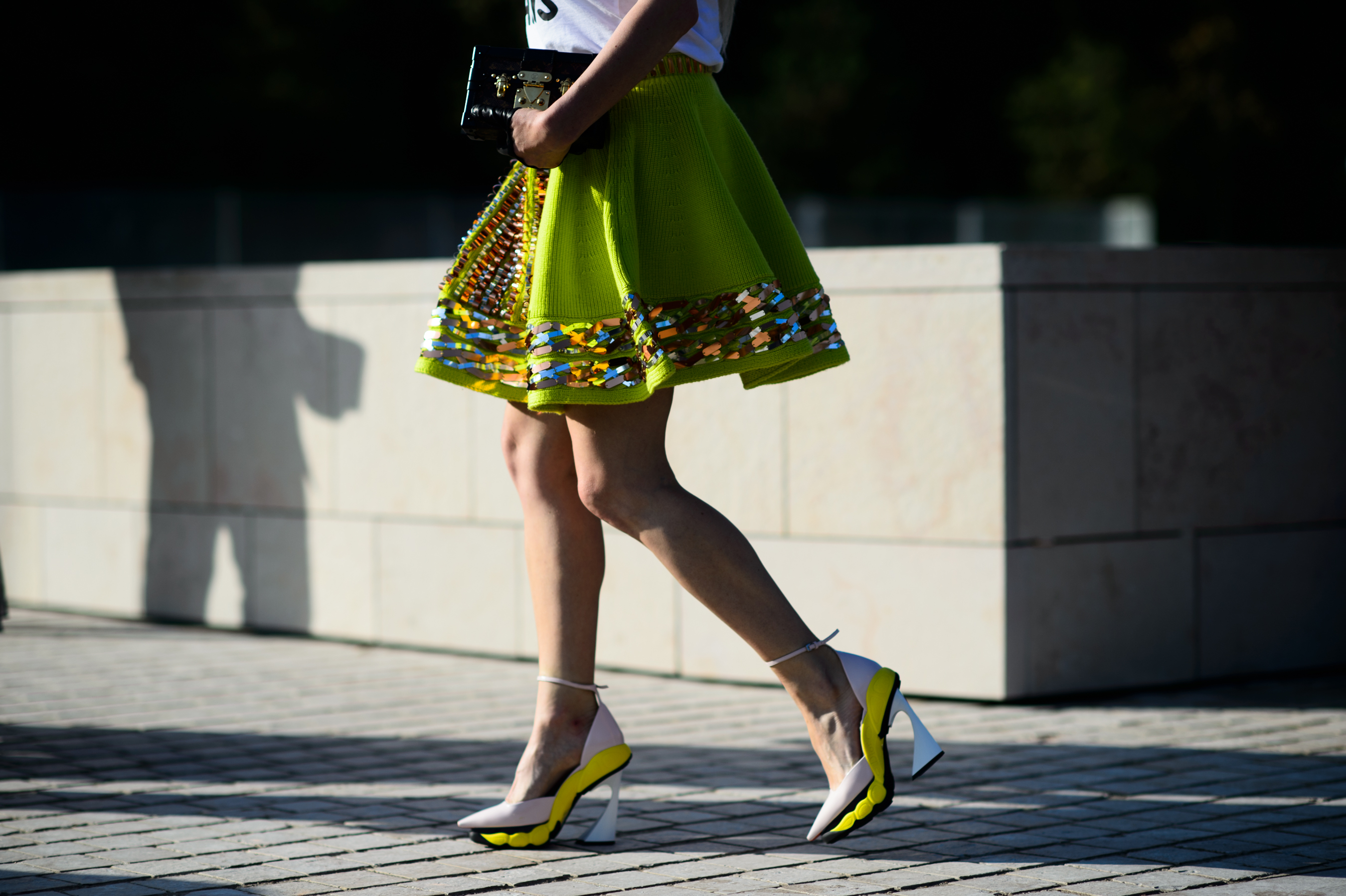 Woman wearing sport high heeled shoes after Louis Vuitton