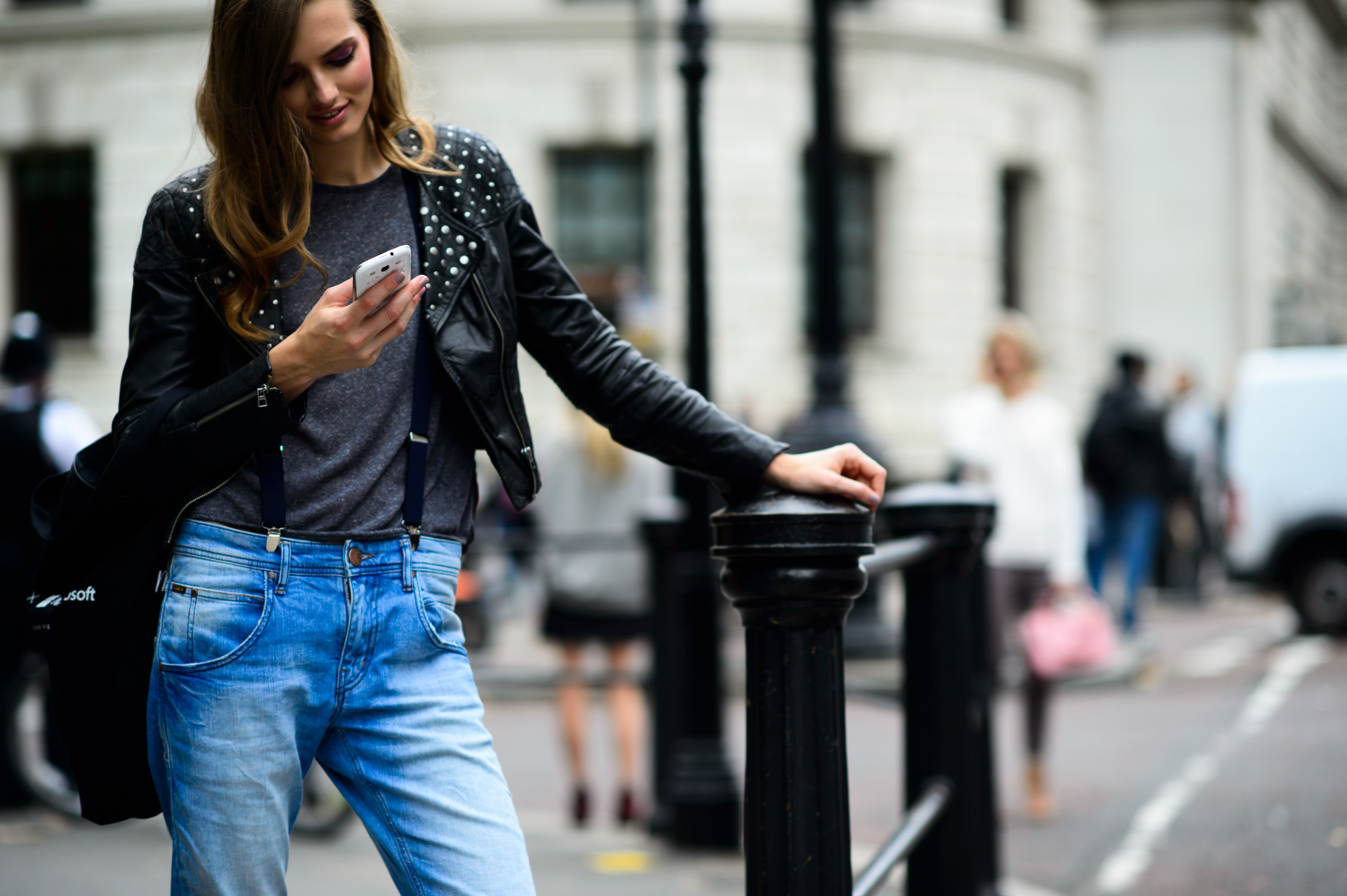 Model wearing leather jacket and blue jeans