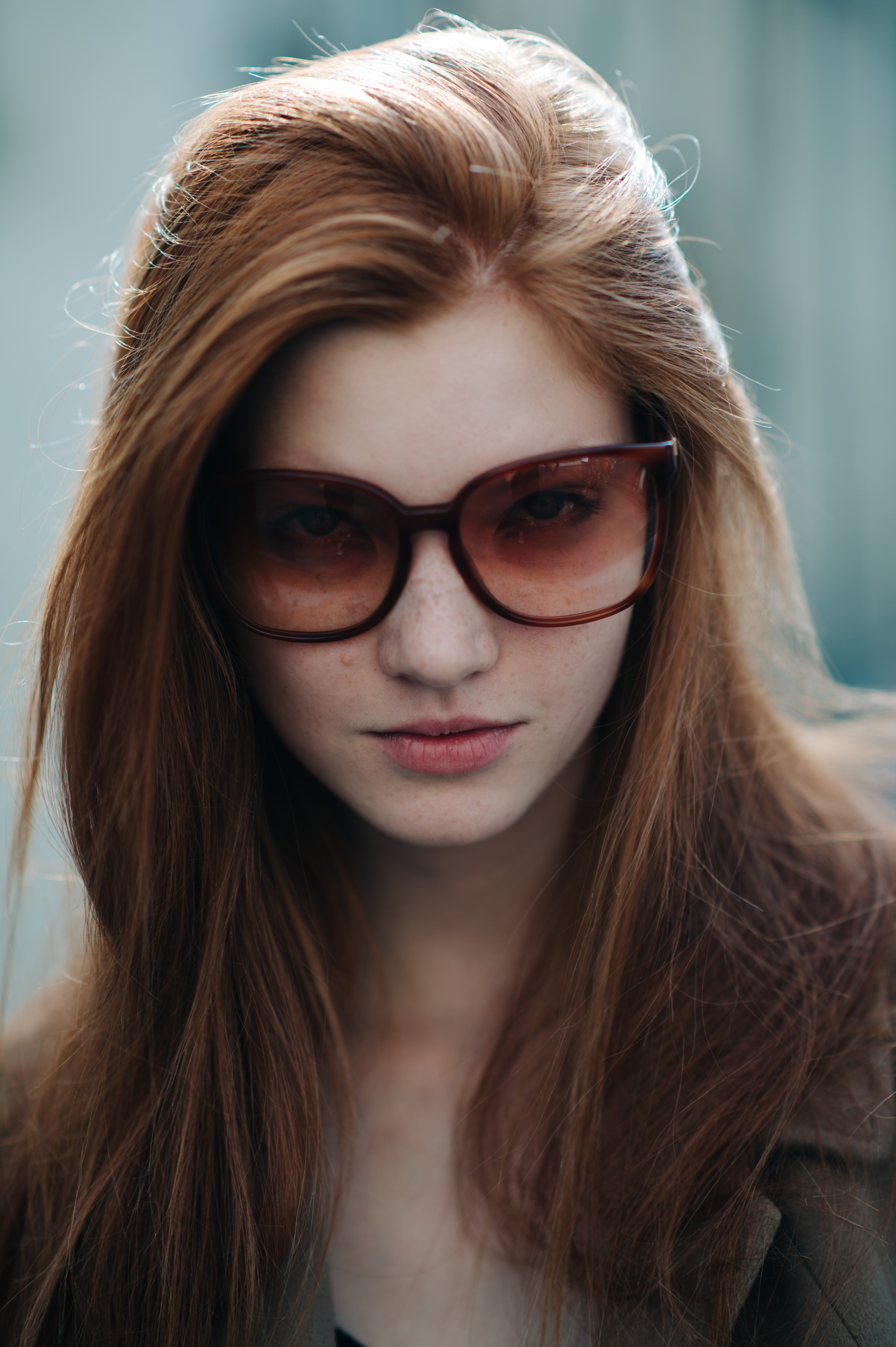 Portrait of a Russian model with red hair and glasses