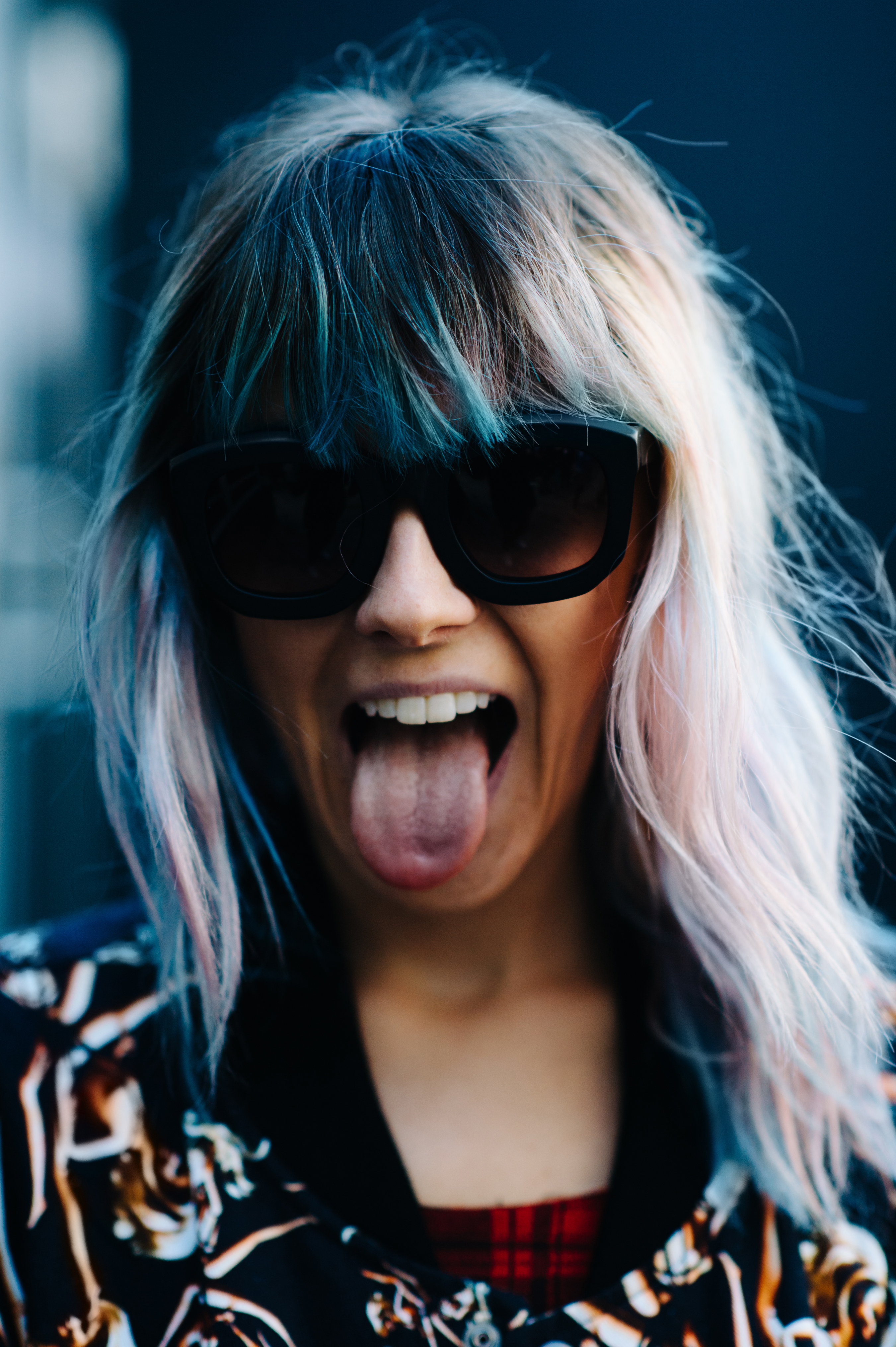 Portrait of a woman with colorful hair wearing glasses