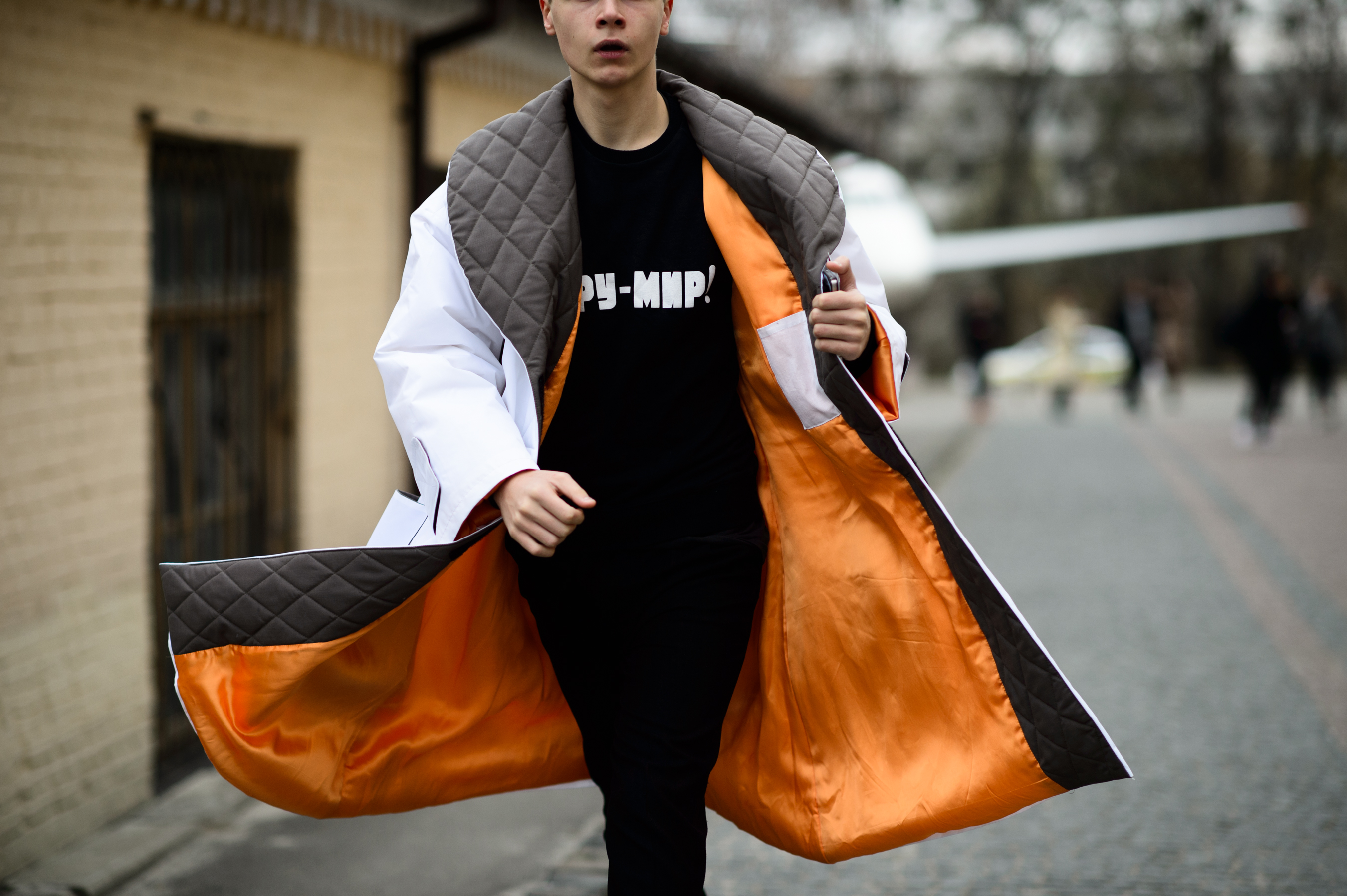 Young Ukrainian designer wearing coat with orange lining