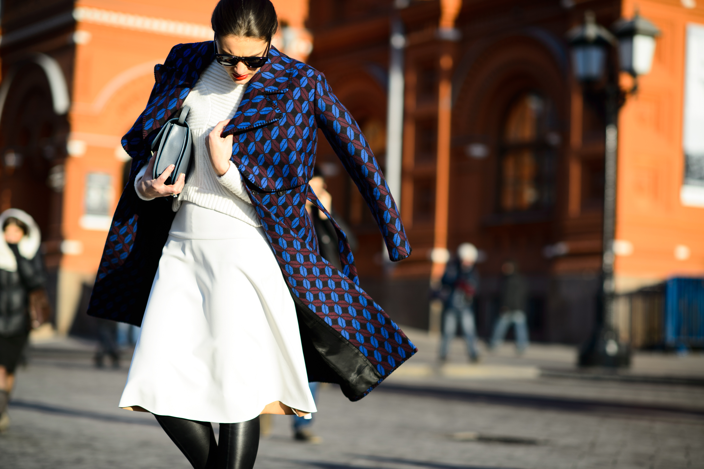 Russian woman wearing coat and white sweater