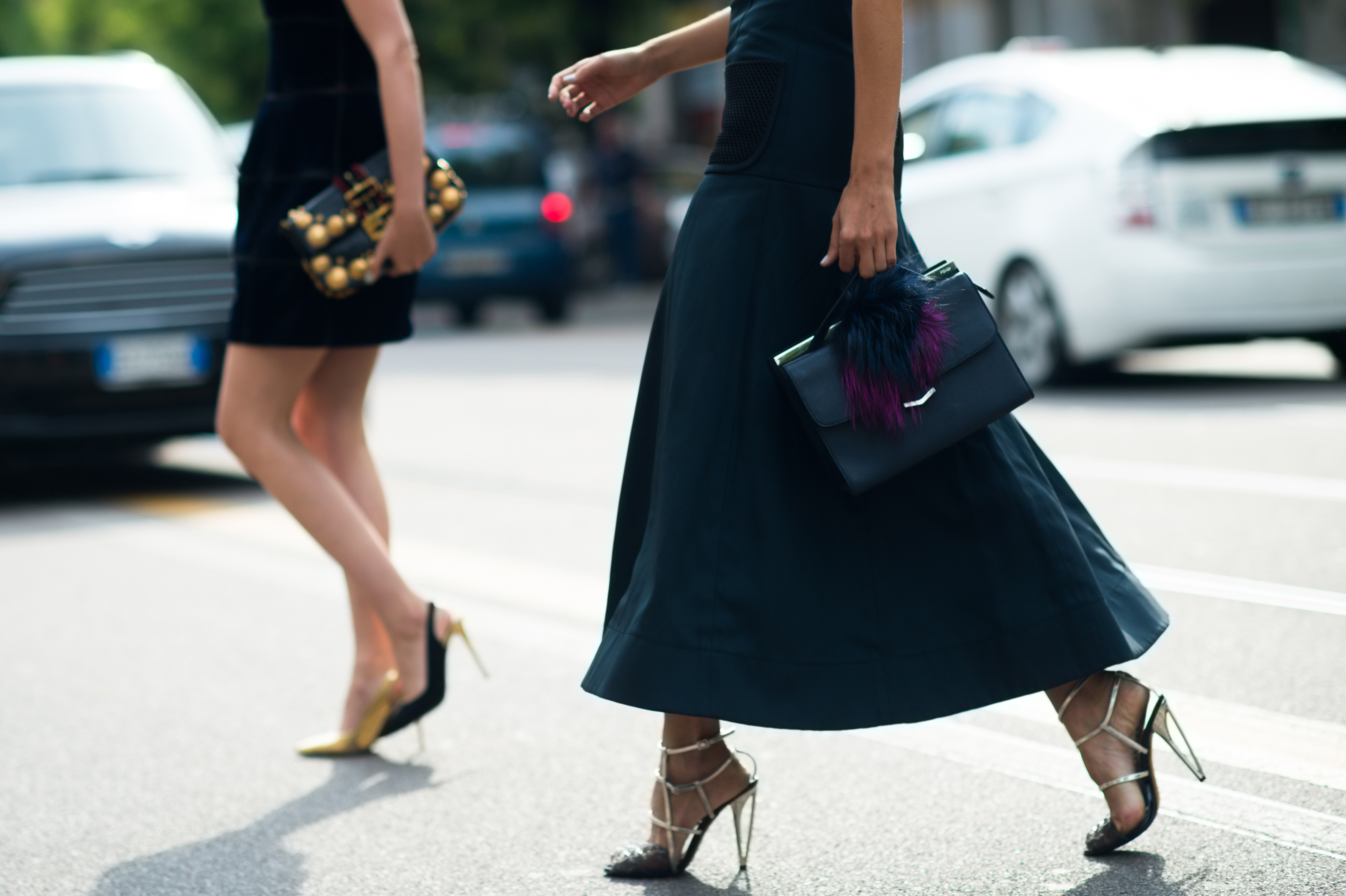 Two women crossing road wearing stiletto shoes