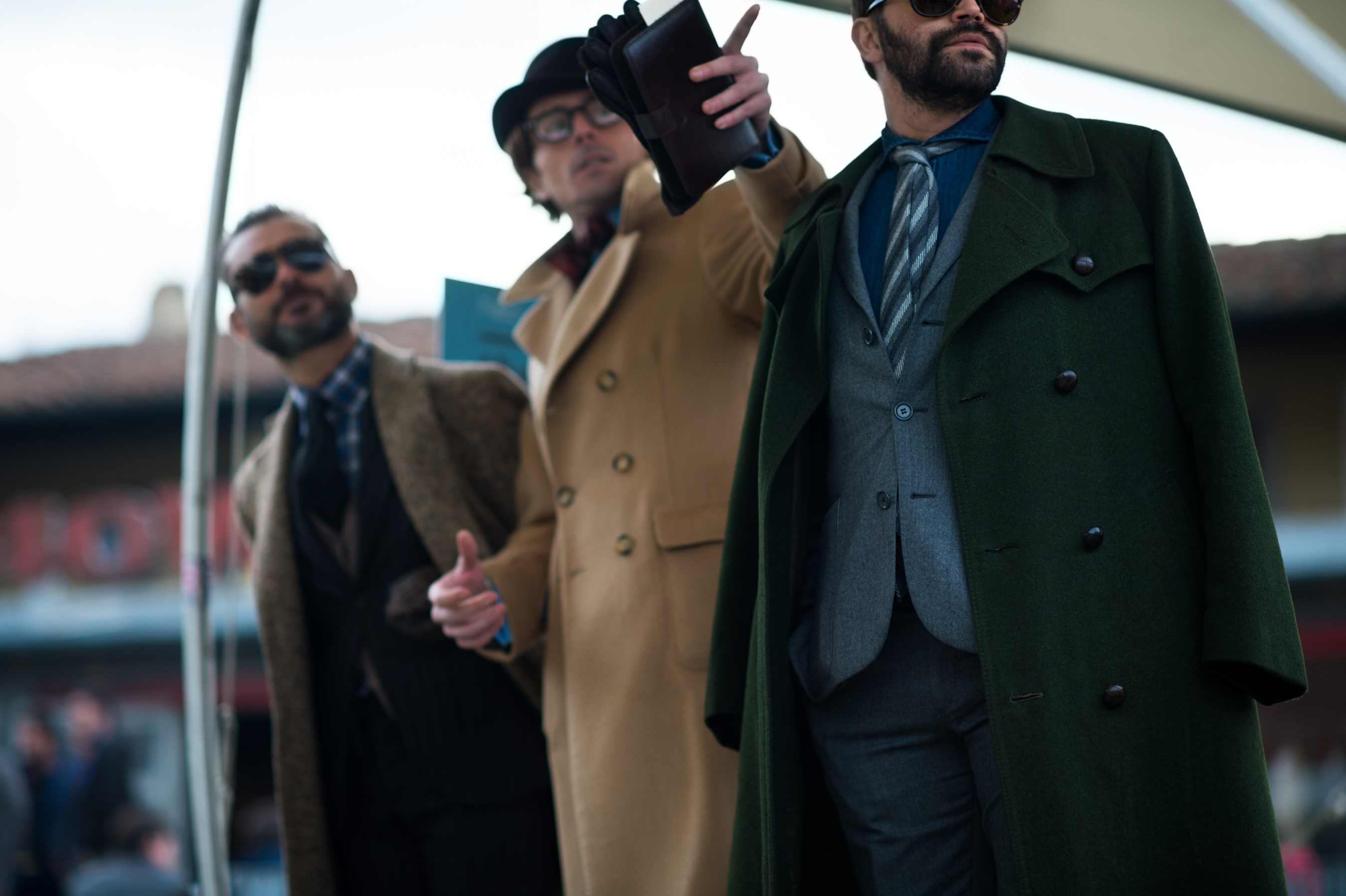 Three men wearing coats