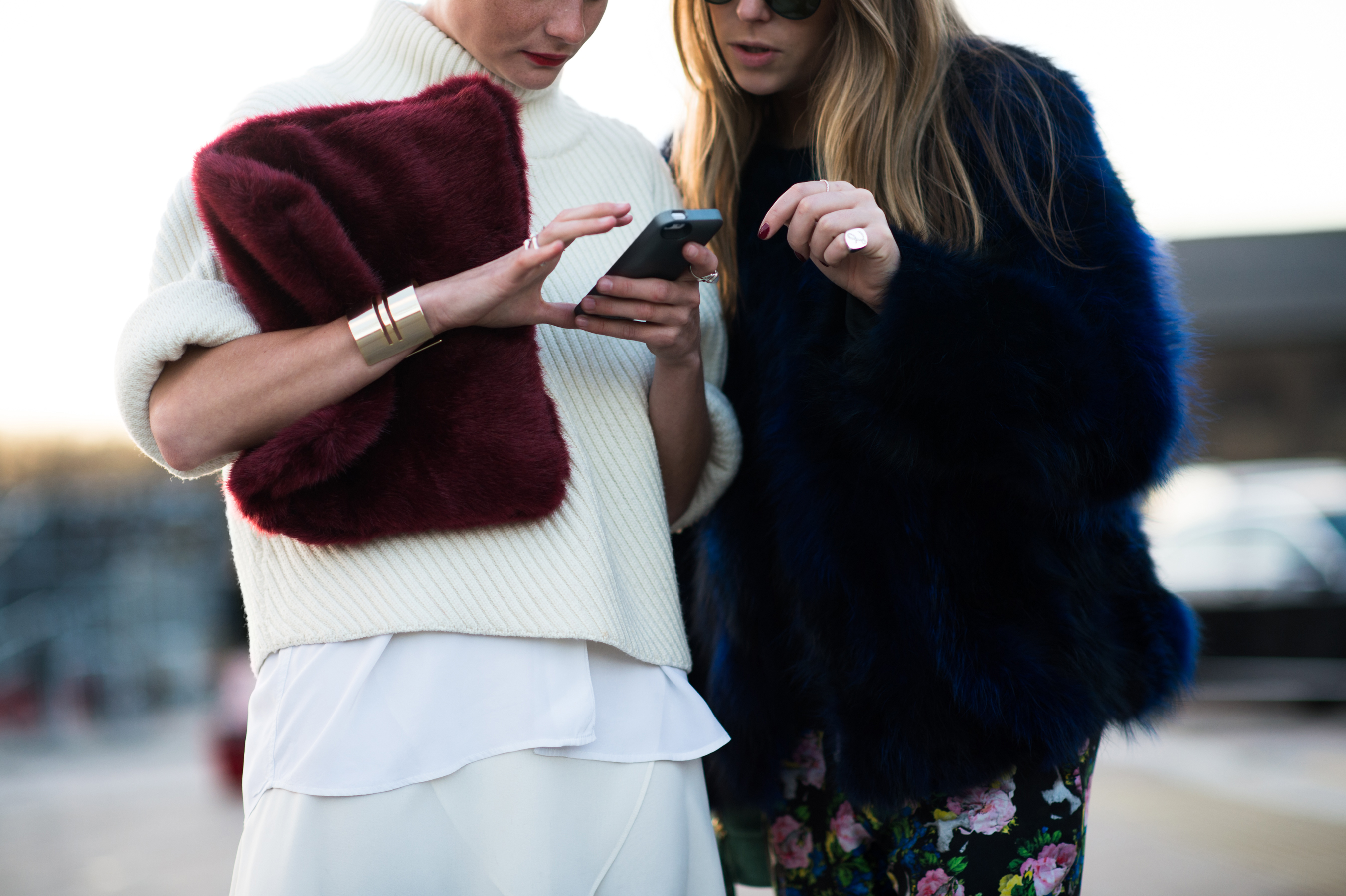 Two women wearing faux fur