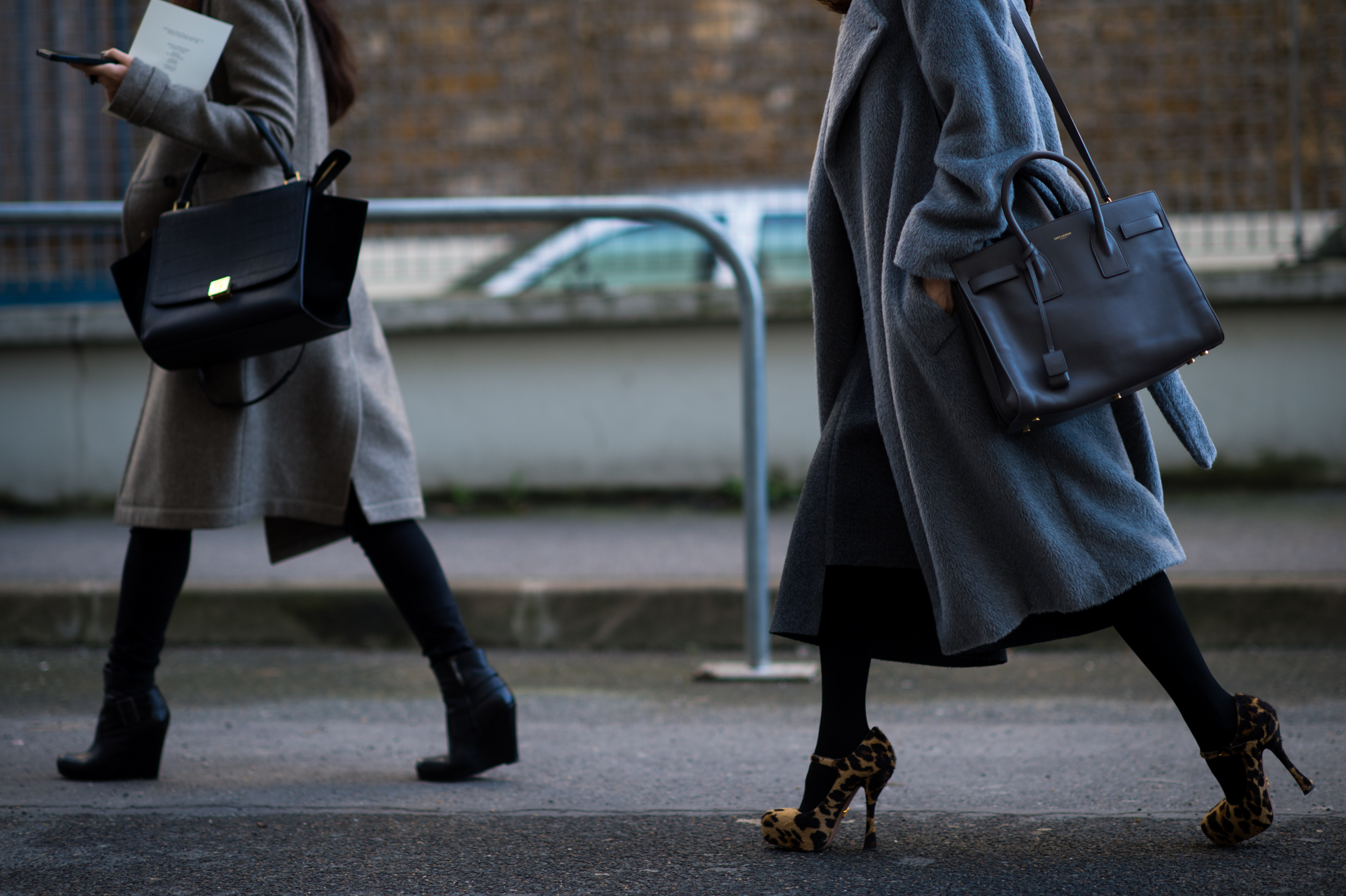 Two women wearing gray coats