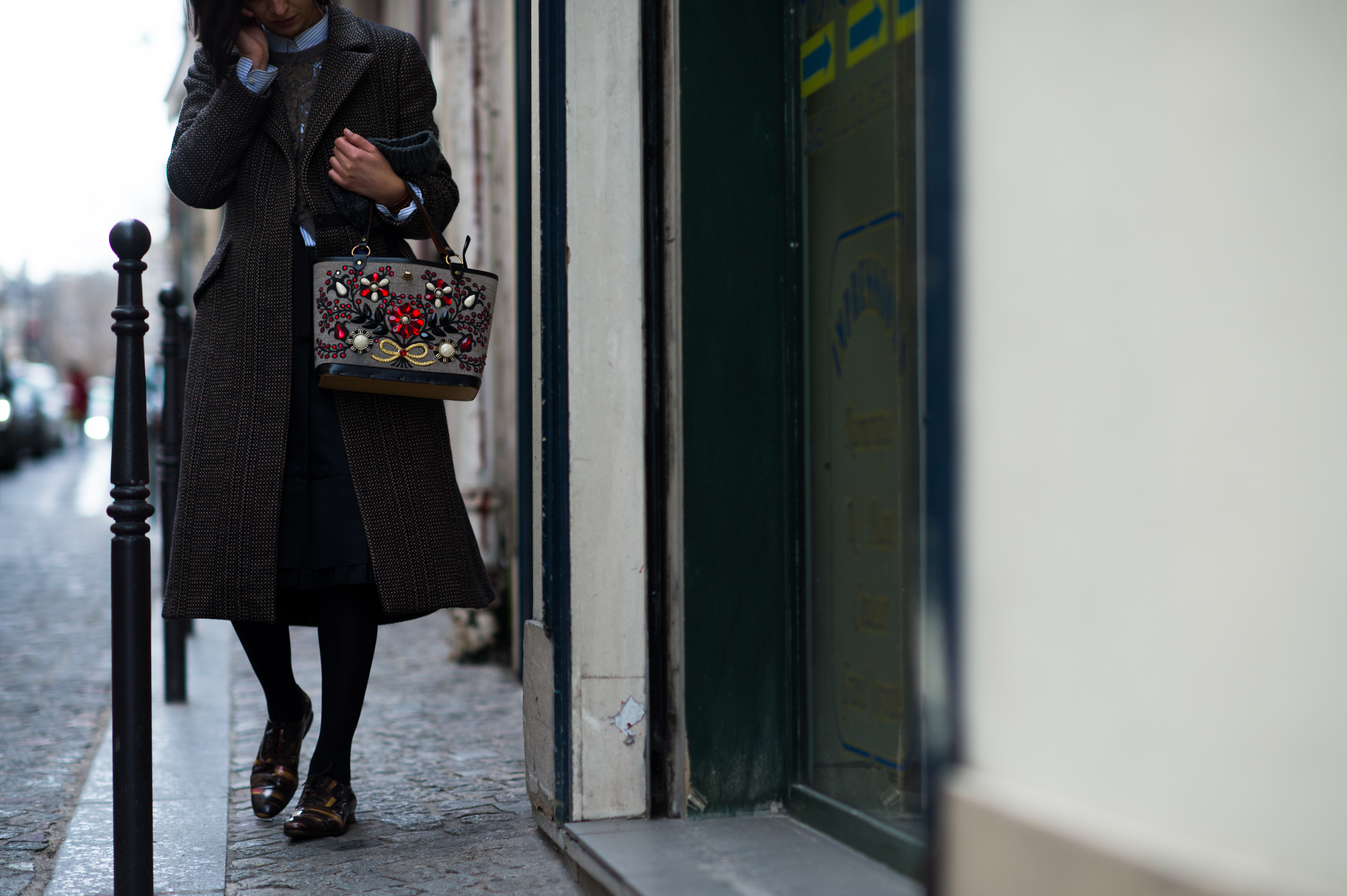 Woman carrying embroidered bag