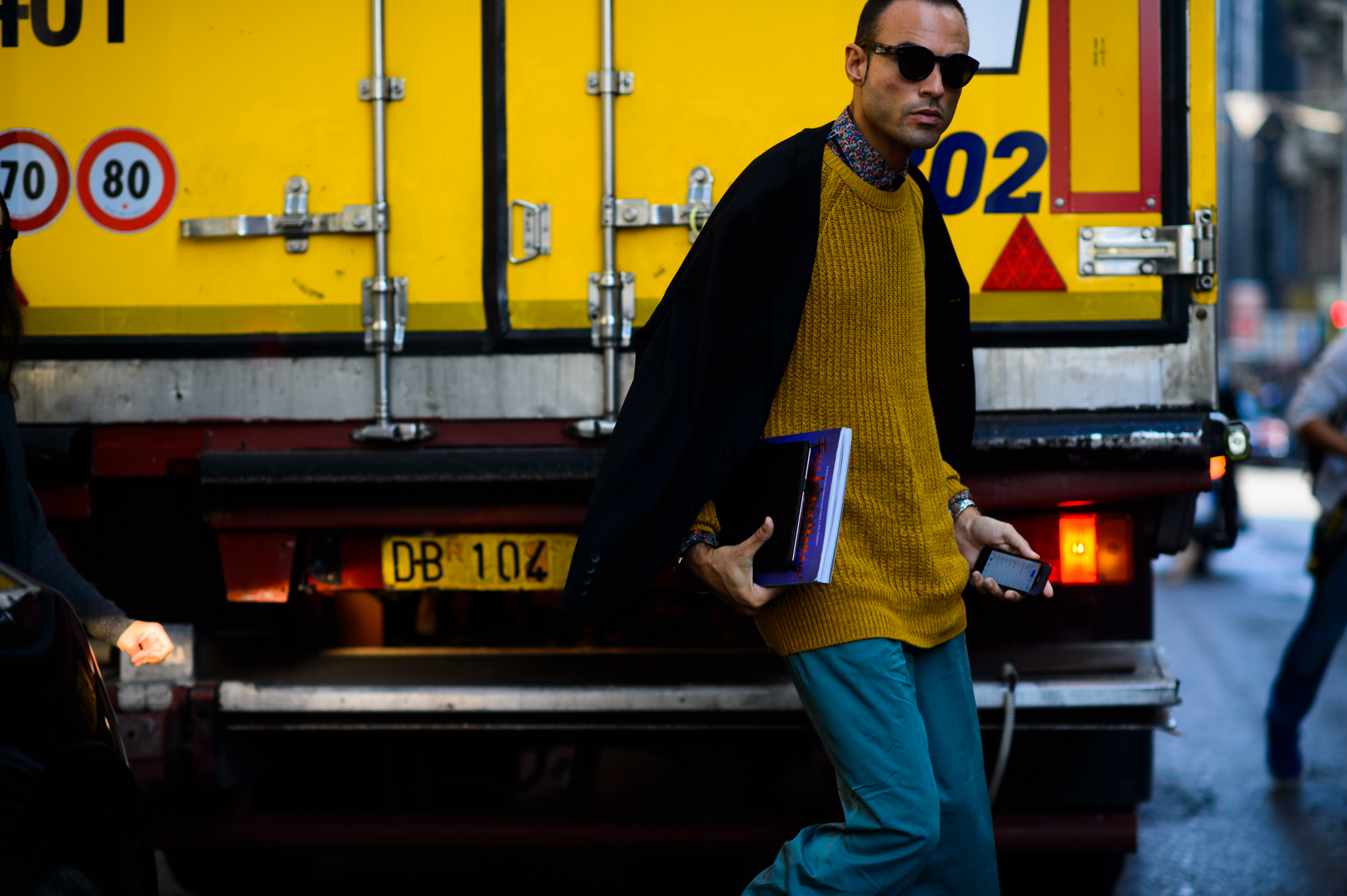 Fucking Young! editor wearing sweater and blue pants