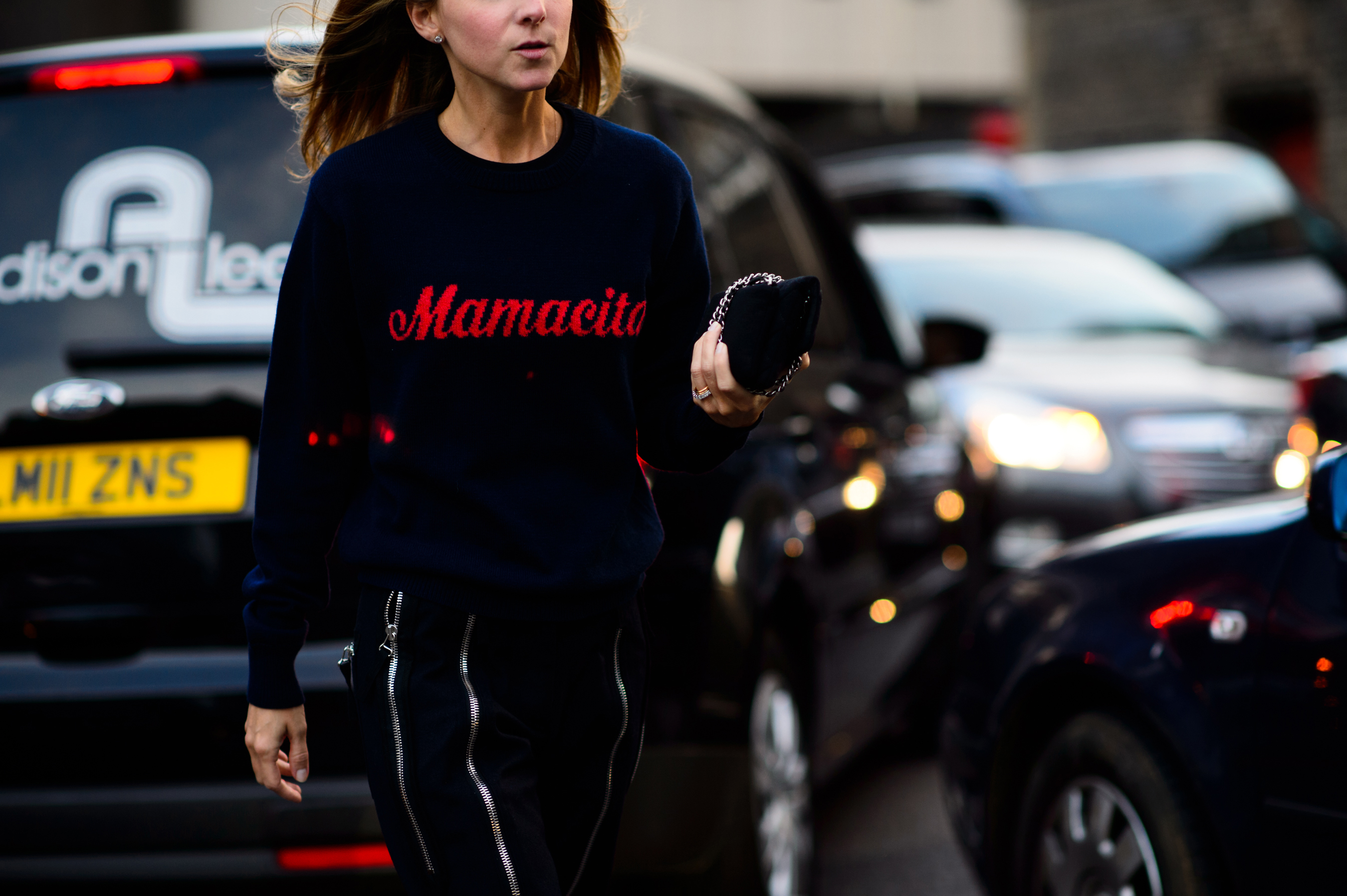 Woman wearing sweater with Mamacito logo
